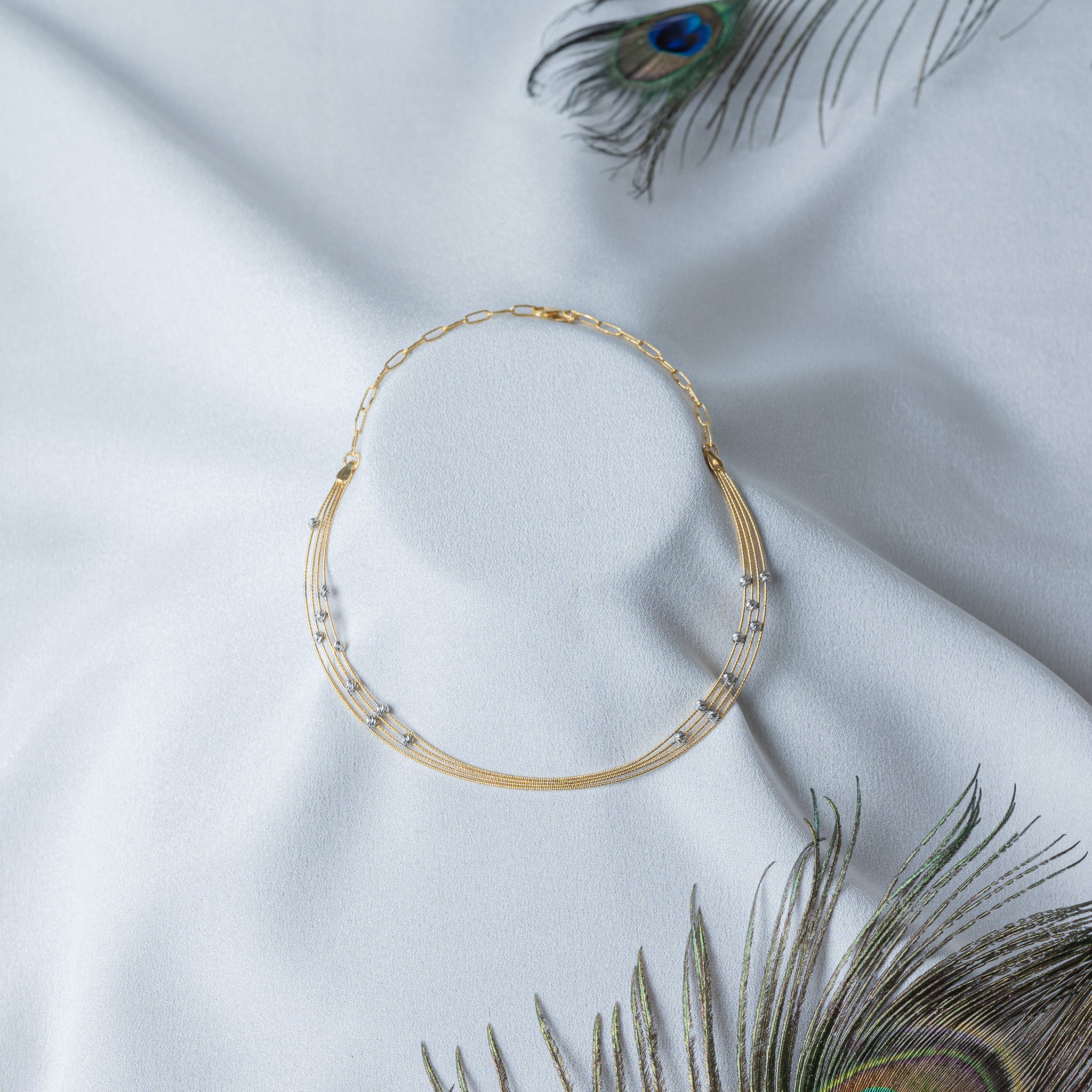Four strand gold collar hasli with faceted white balls scattered along fine chains, 925 silver