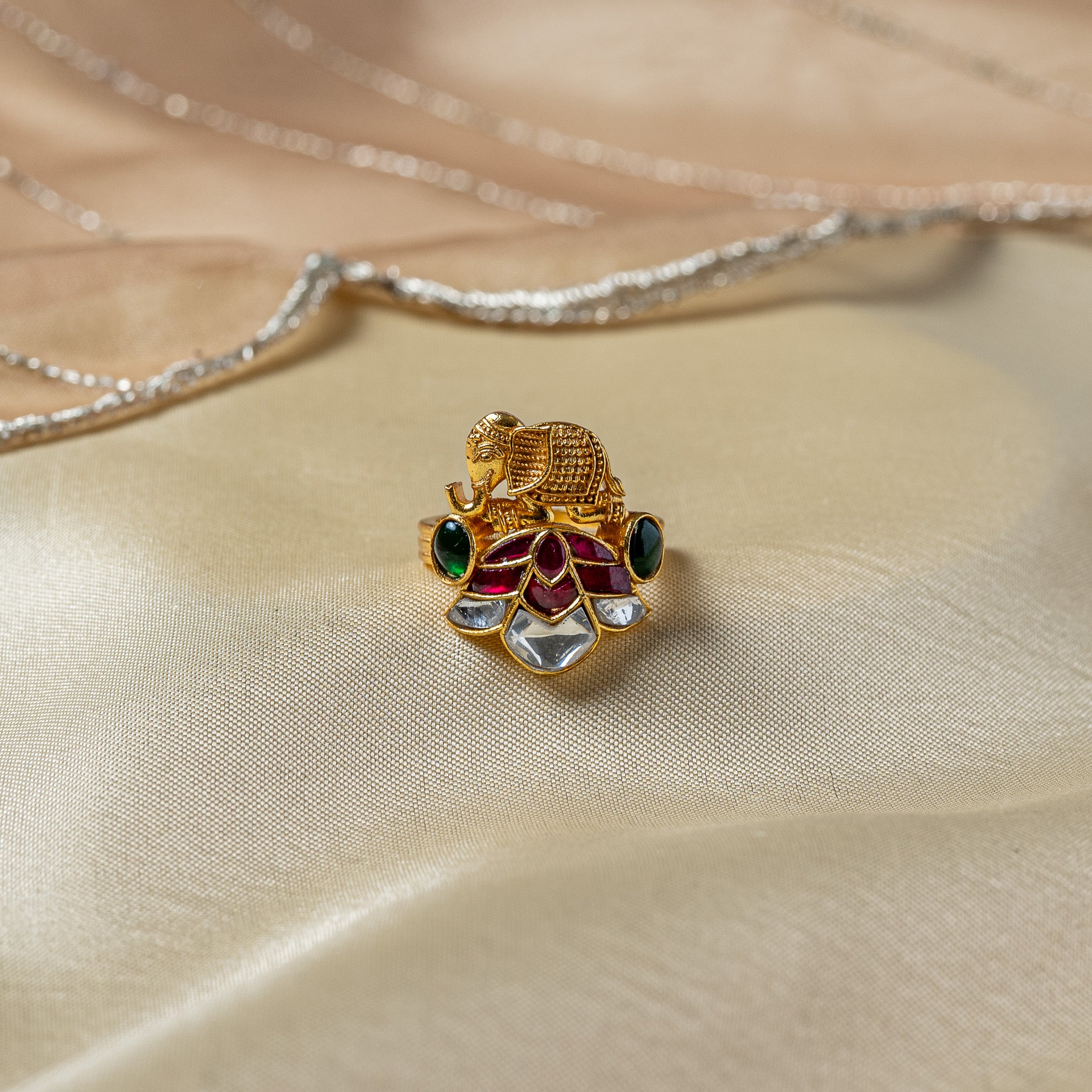 Temple elephant ring standing on a red and white kundan lotus in antique gold plated 925 silver