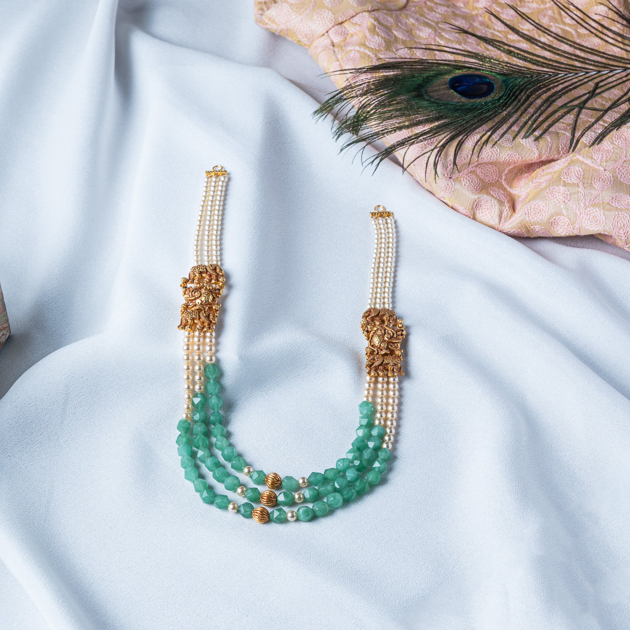 Nakaas elephant necklace on three strands of shell pearls and mint green beads, gold plated 925 silver