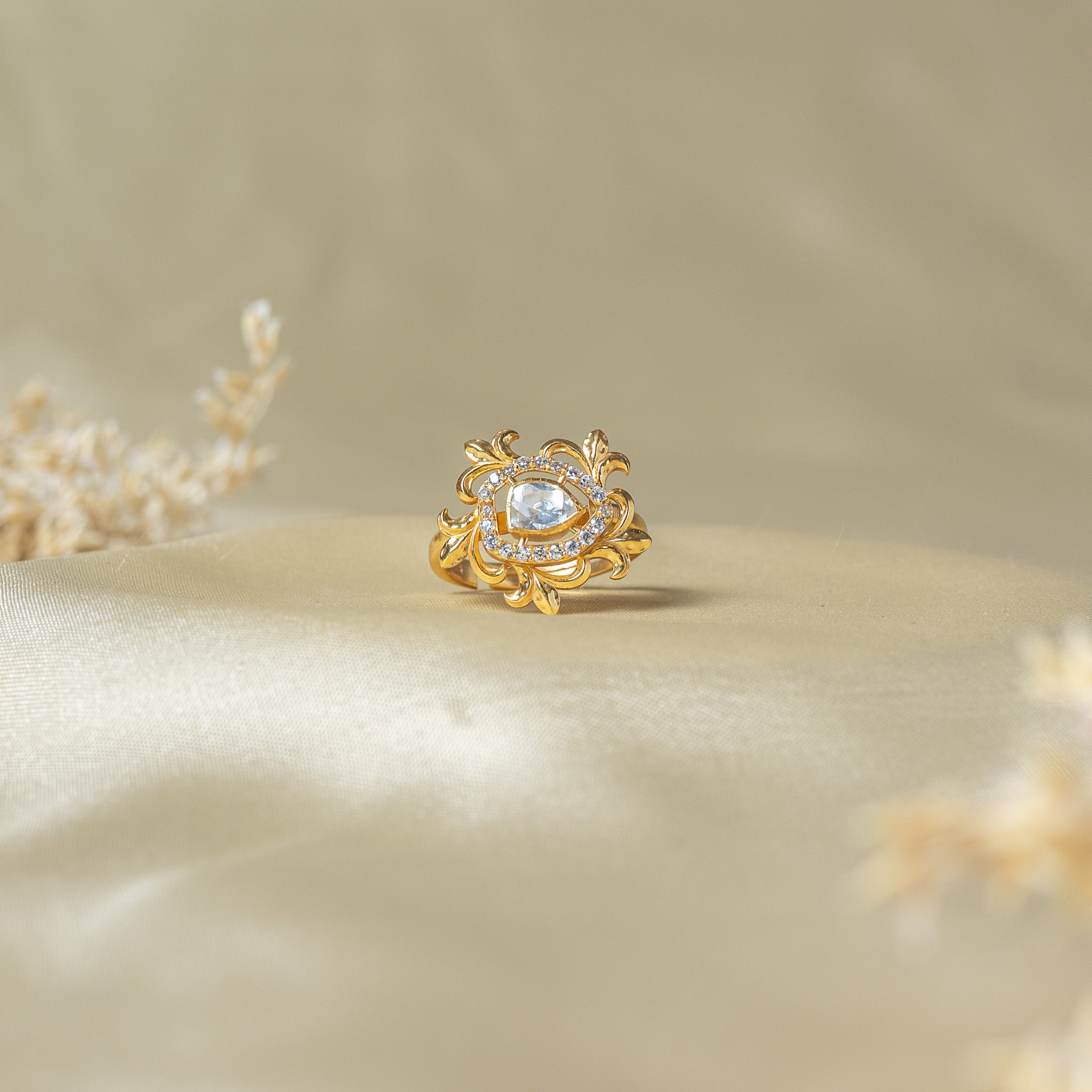 Leaf scroll ring with a pear shaped polki in a CZ halo inside a sunburst of gold scrolls, 925 silver