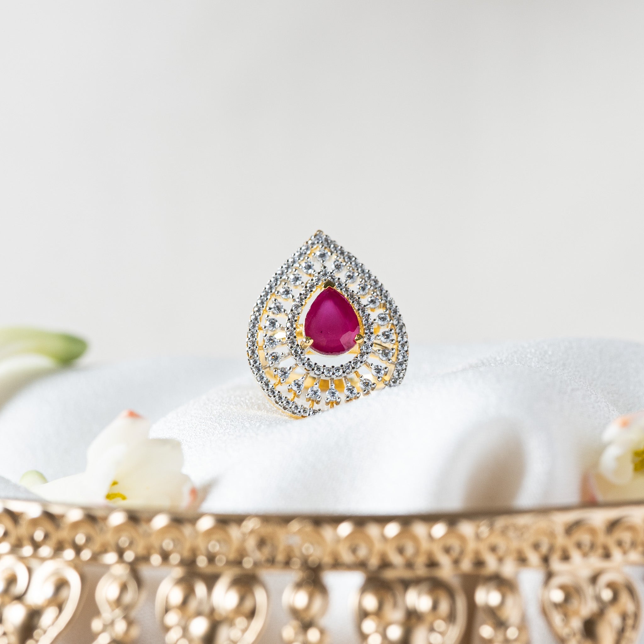Pink pear cut stone in a teardrop of white CZ, gold plated 925 silver cocktail ring