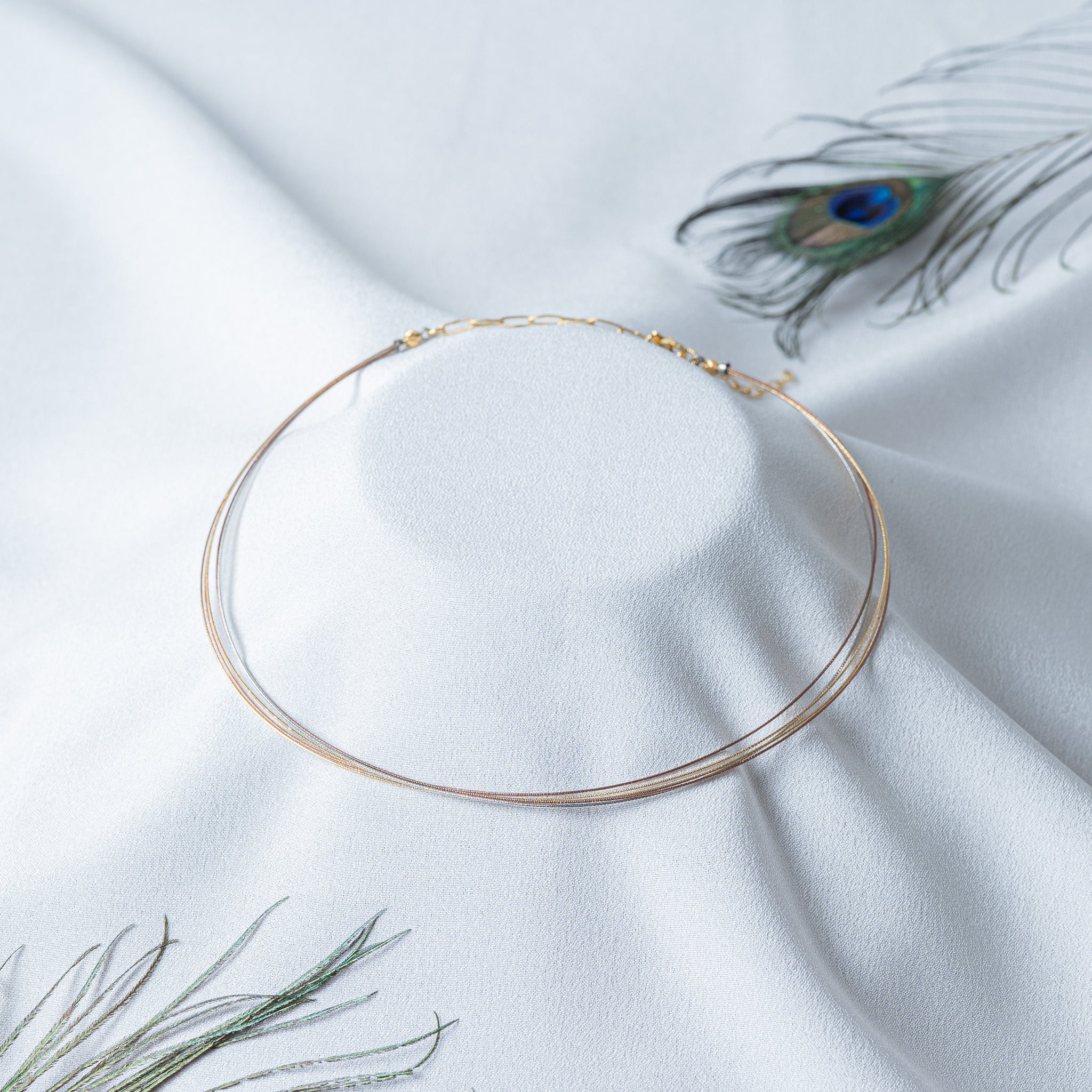 Tri tone floating wire collar in yellow, rose and white gold plated 925 silver, shown flat