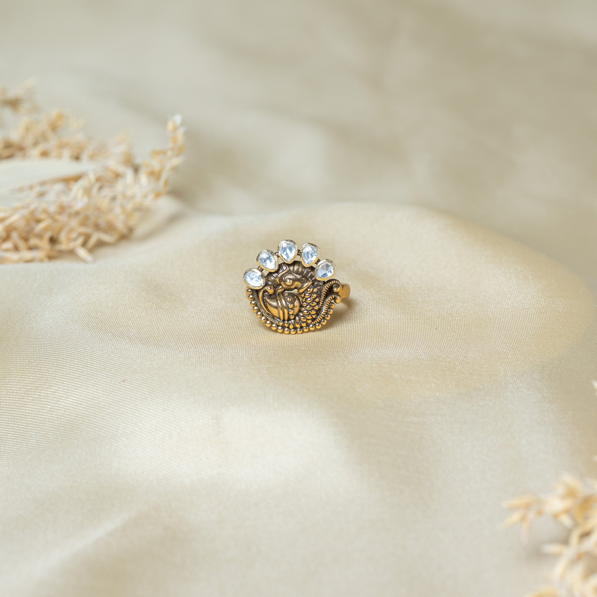 Victorian peacock ring with five uncut stones fanned as the tail over a granulated bird