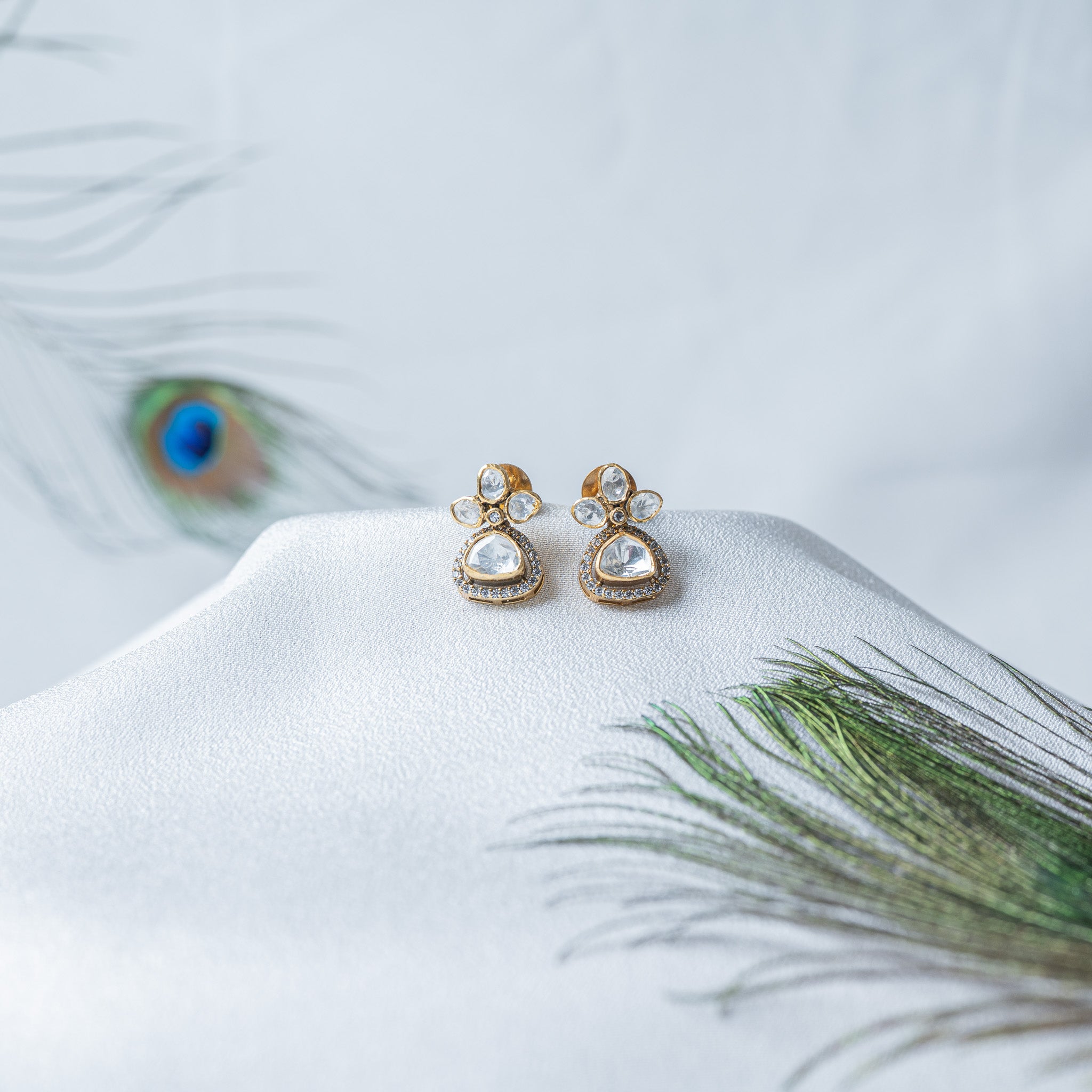 Victorian earrings with a trefoil of three pear cut uncut stones over a haloed trillion drop