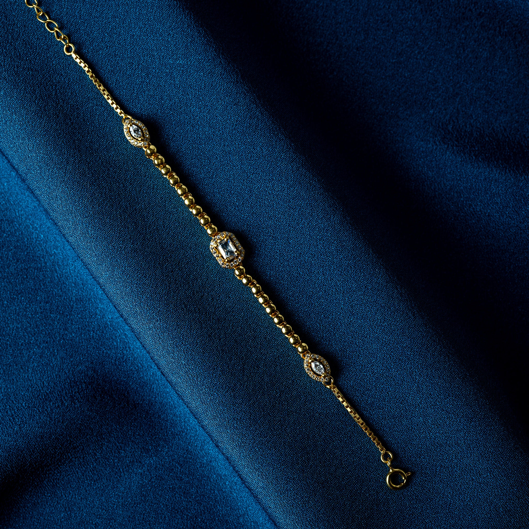 Close crop of the centre step cut CZ in its pave halo with a fine beaded rim