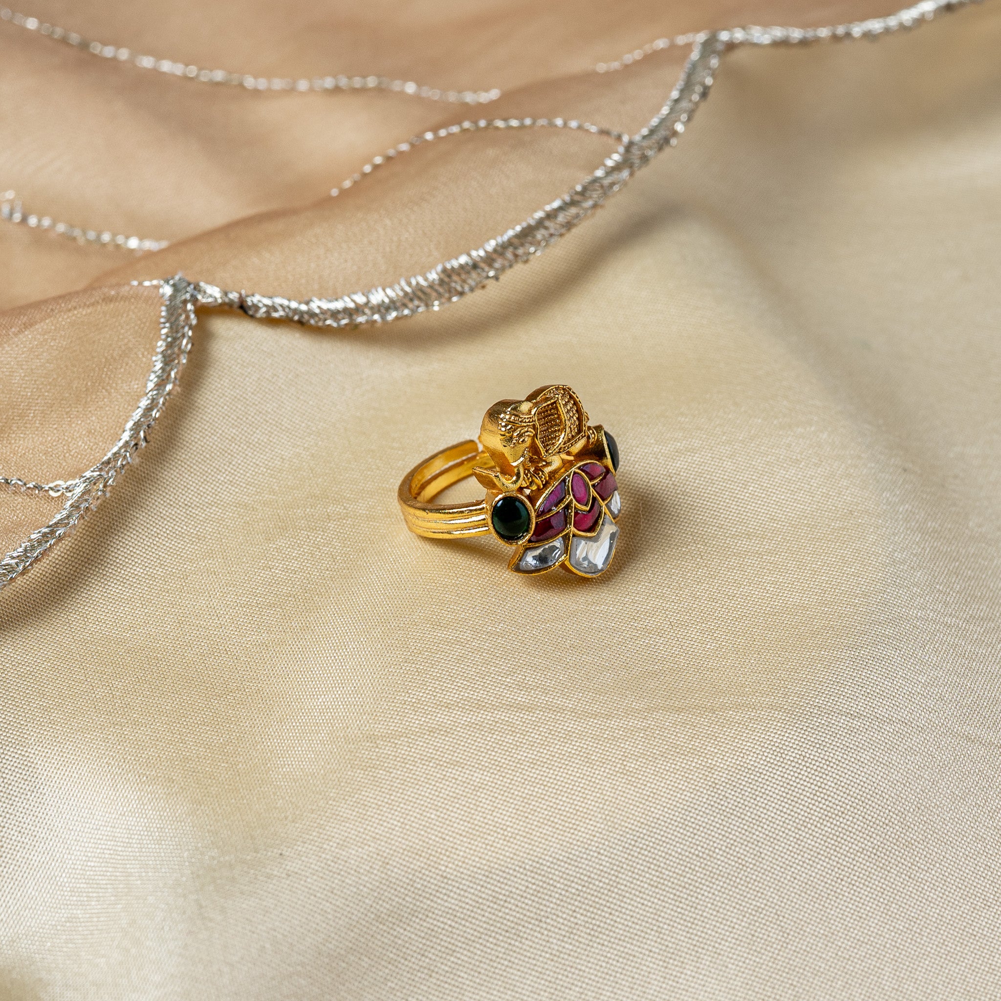 Side view of the elephant ring showing the domed green cabochon set into the shoulder of the band
