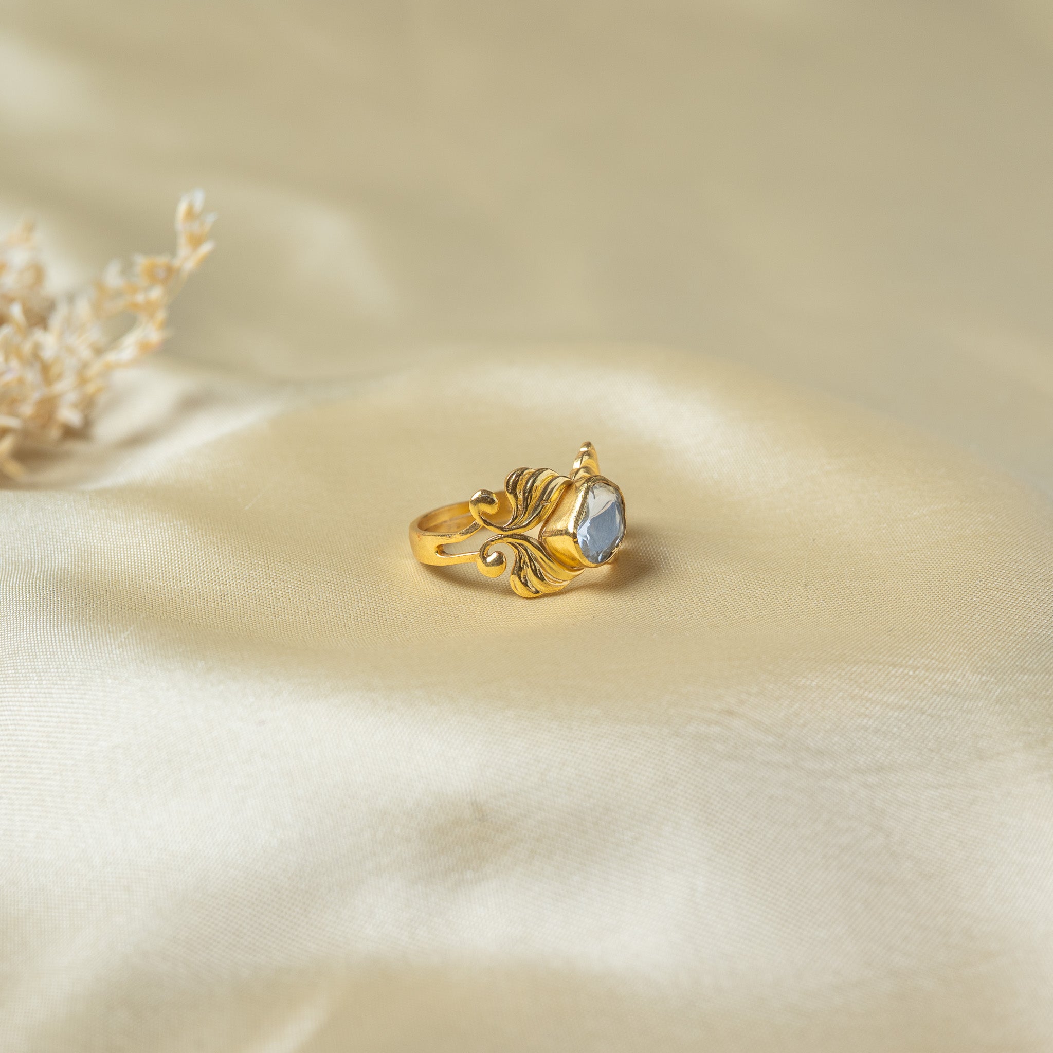 Side view of the raised polki setting and the curling plumes on the shoulders of the ring