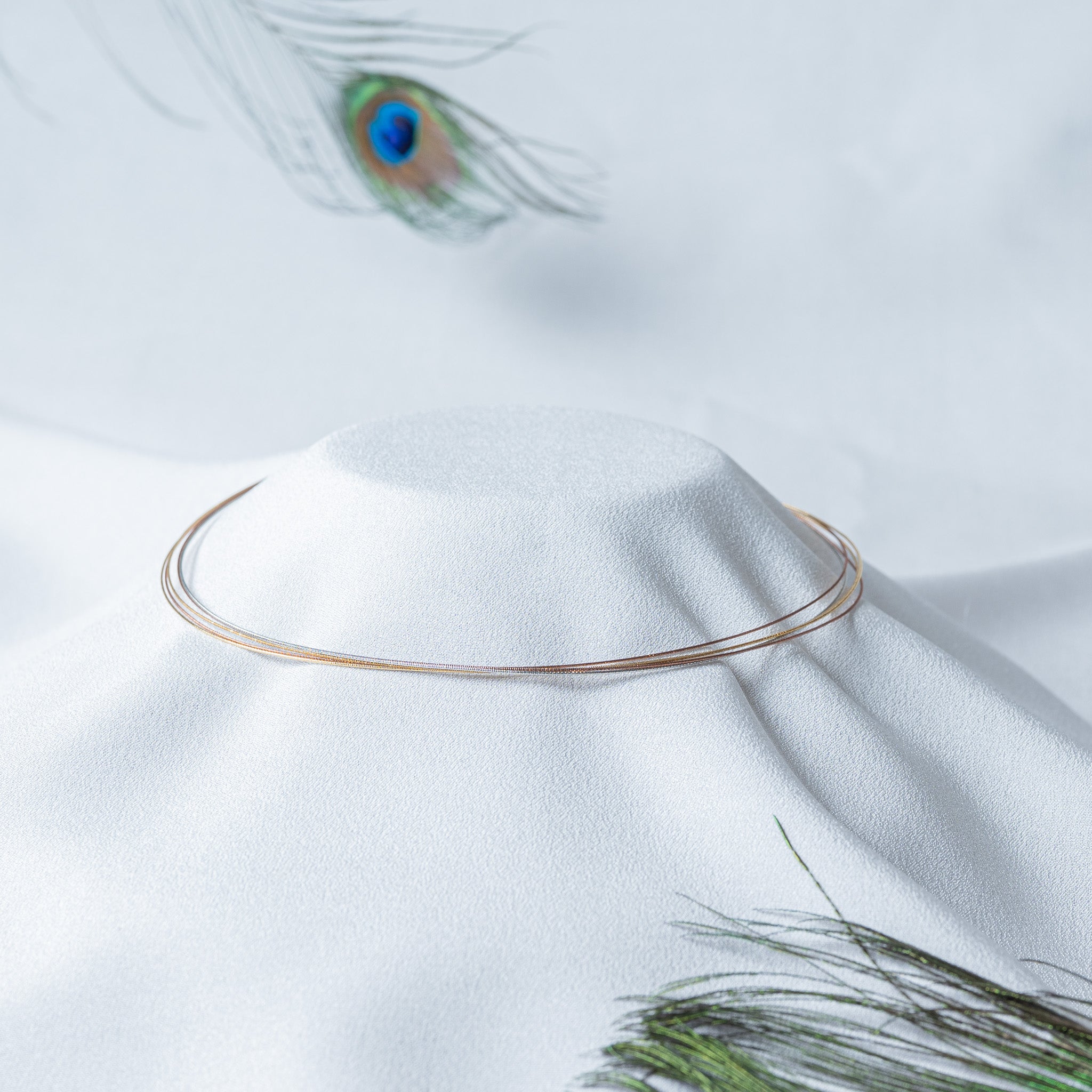 Tri tone wire collar on a bust, three fine strands floating one inside the other