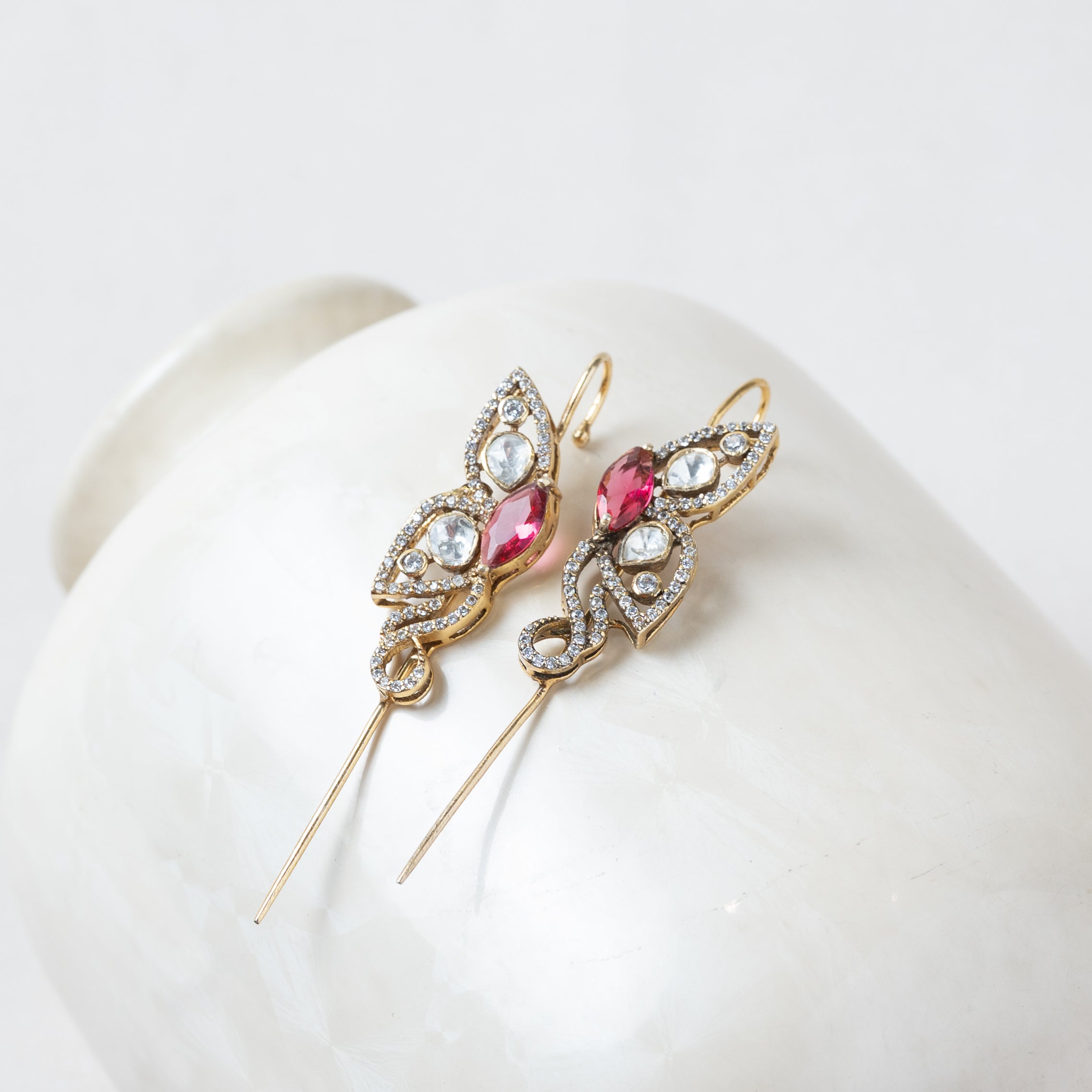 Side view of the ear cuff showing the gold wire that curves over the top of the ear