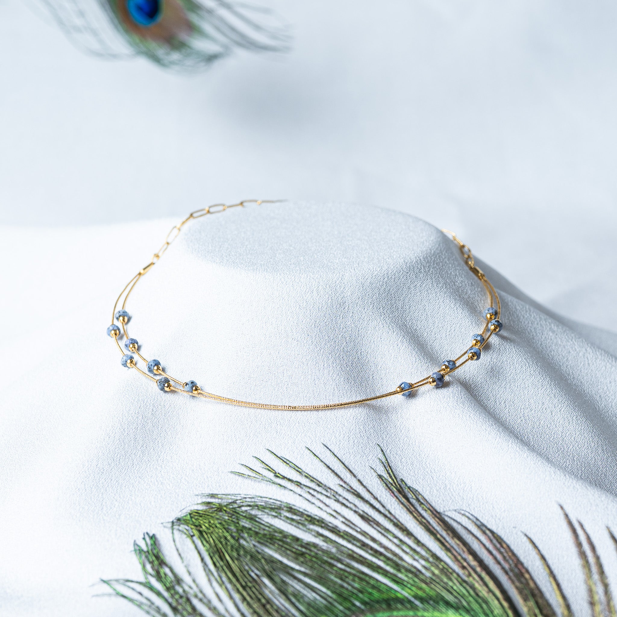 Front view of the double strand gold collar with the bead stations offset