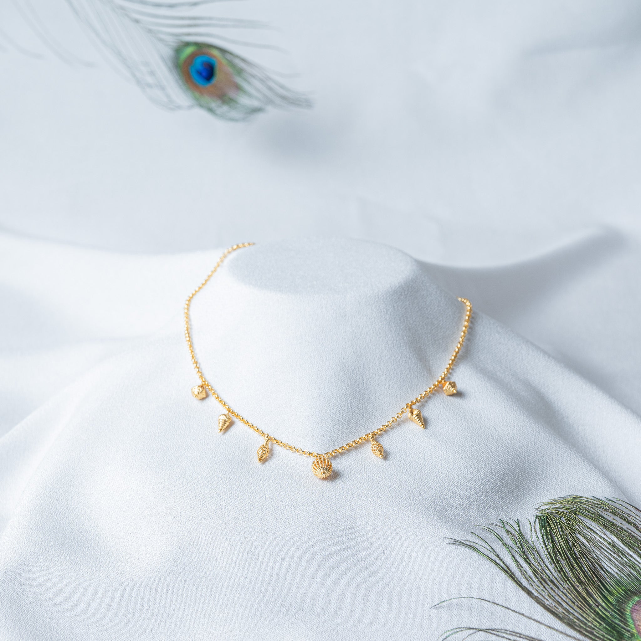 Front view of the charm chain with the seven charms spaced evenly along the links