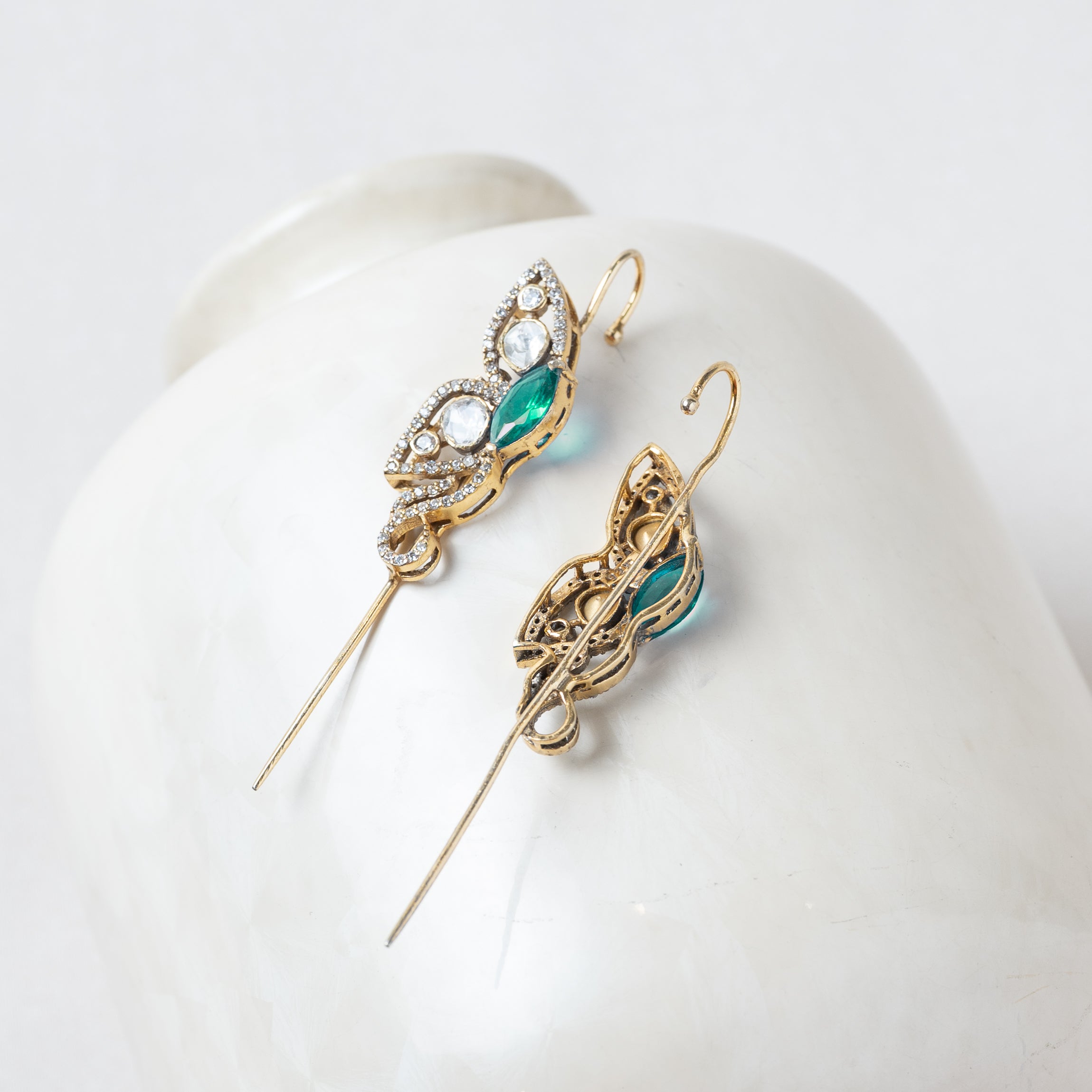 Back of the green ear cuff showing the lobe post and the open wire that hooks over the ear