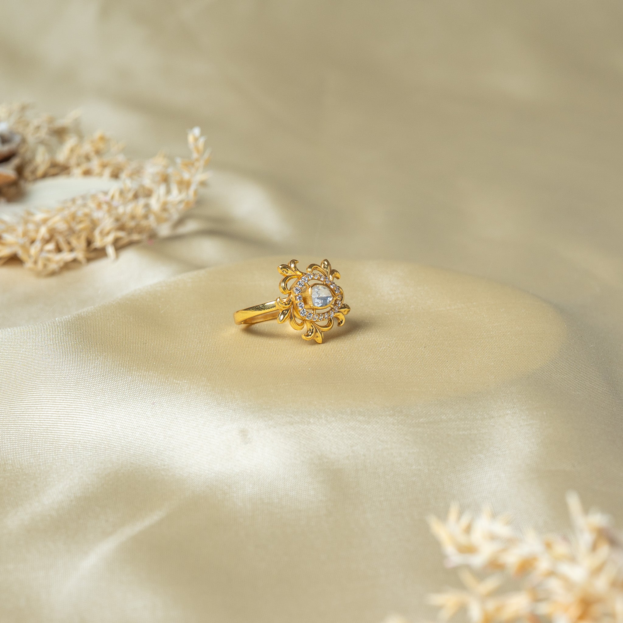 Side view of the ring showing the pierced leaf scrolls standing off the plain tapered band