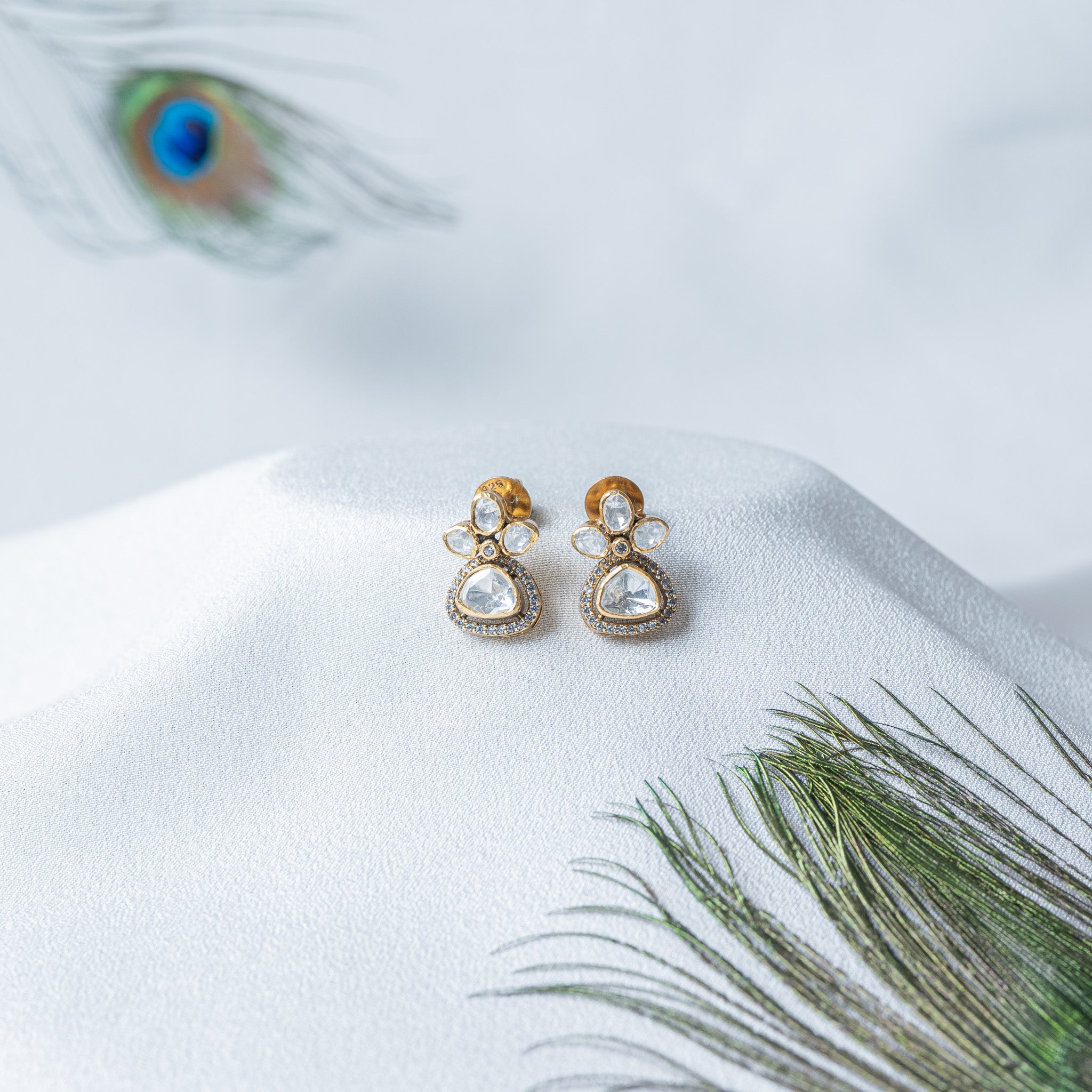 Front view of the pear cut trefoil and the small CZ at the joint above the hanging trillion