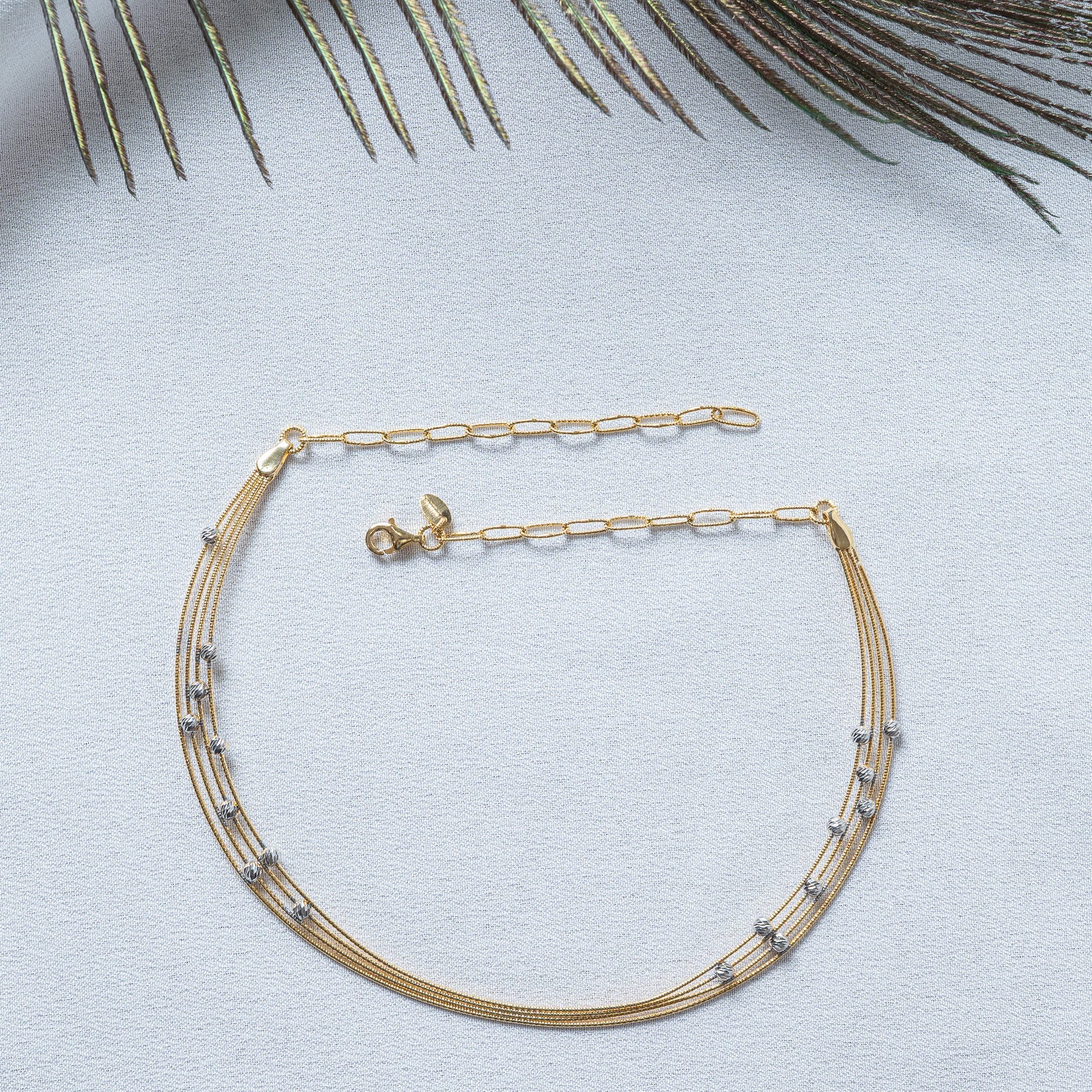Lobster clasp, teardrop tag and flat paperclip extender on the four strand chain