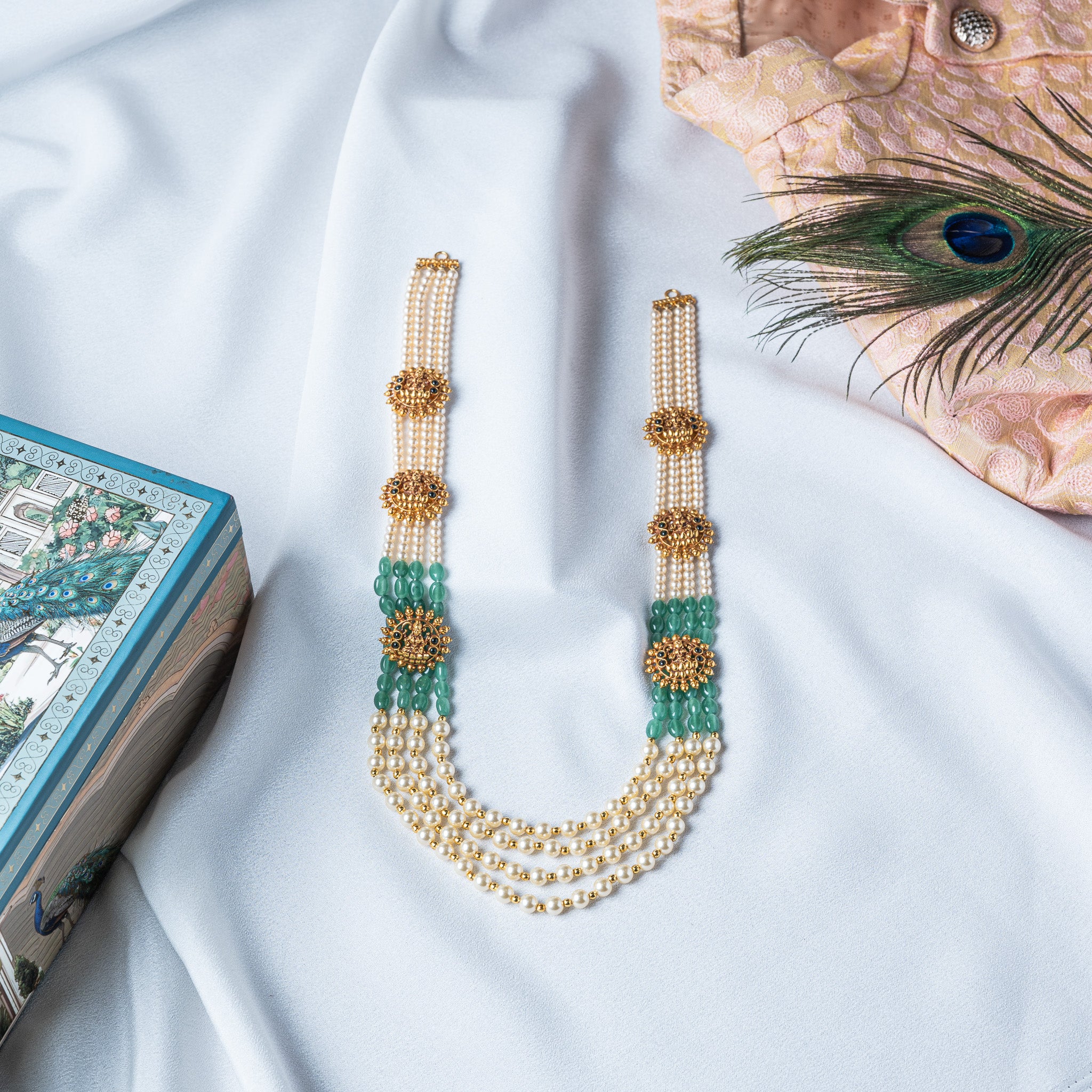 Lakshmi nakaas necklace laid flat with all four strands and six gold motifs visible