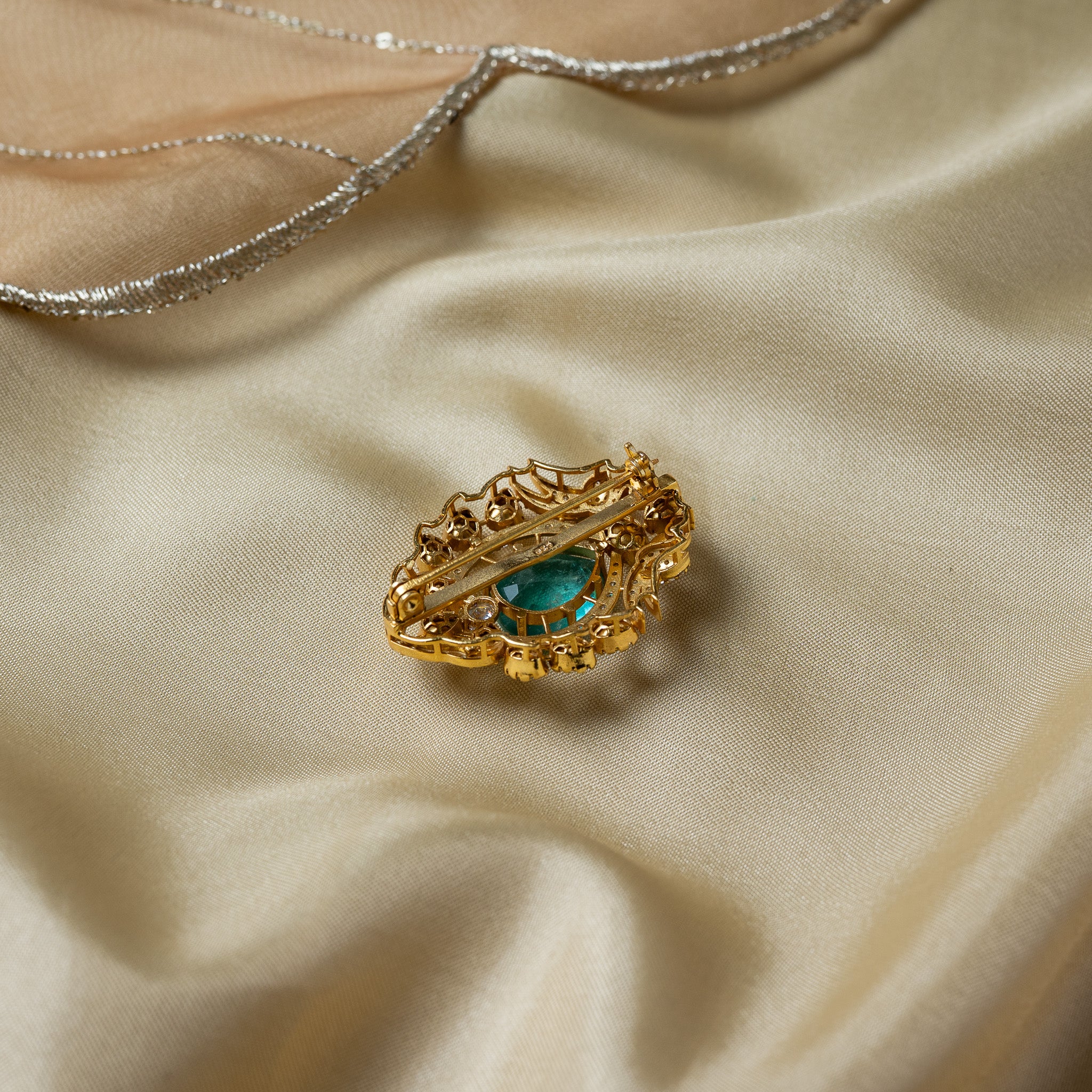 Back of the lotus brooch with the flat mounting bar, steel pin, rolled hinge and hook catch