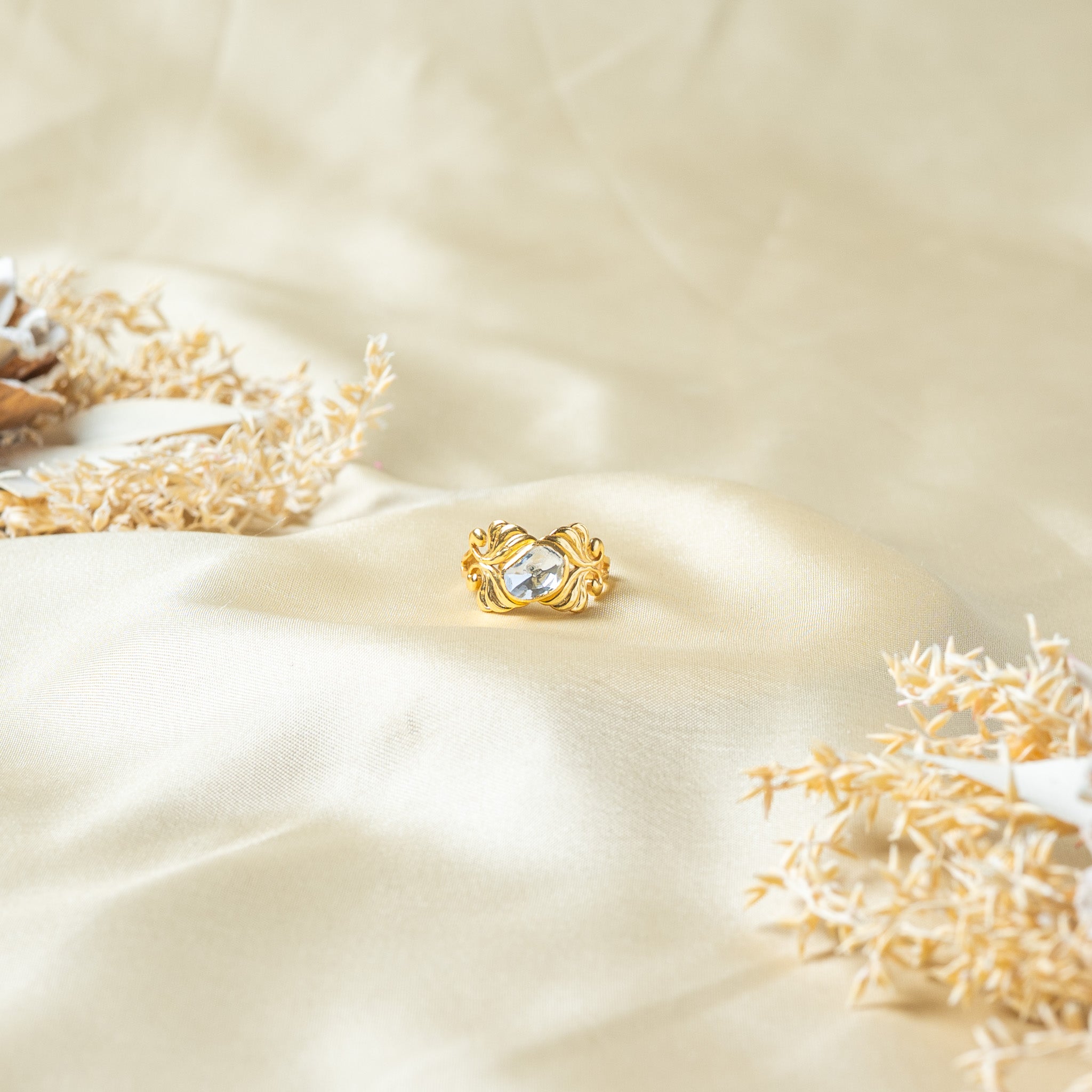 Flat lay of the leaf scroll ring with antique shading worked into the engraved veining