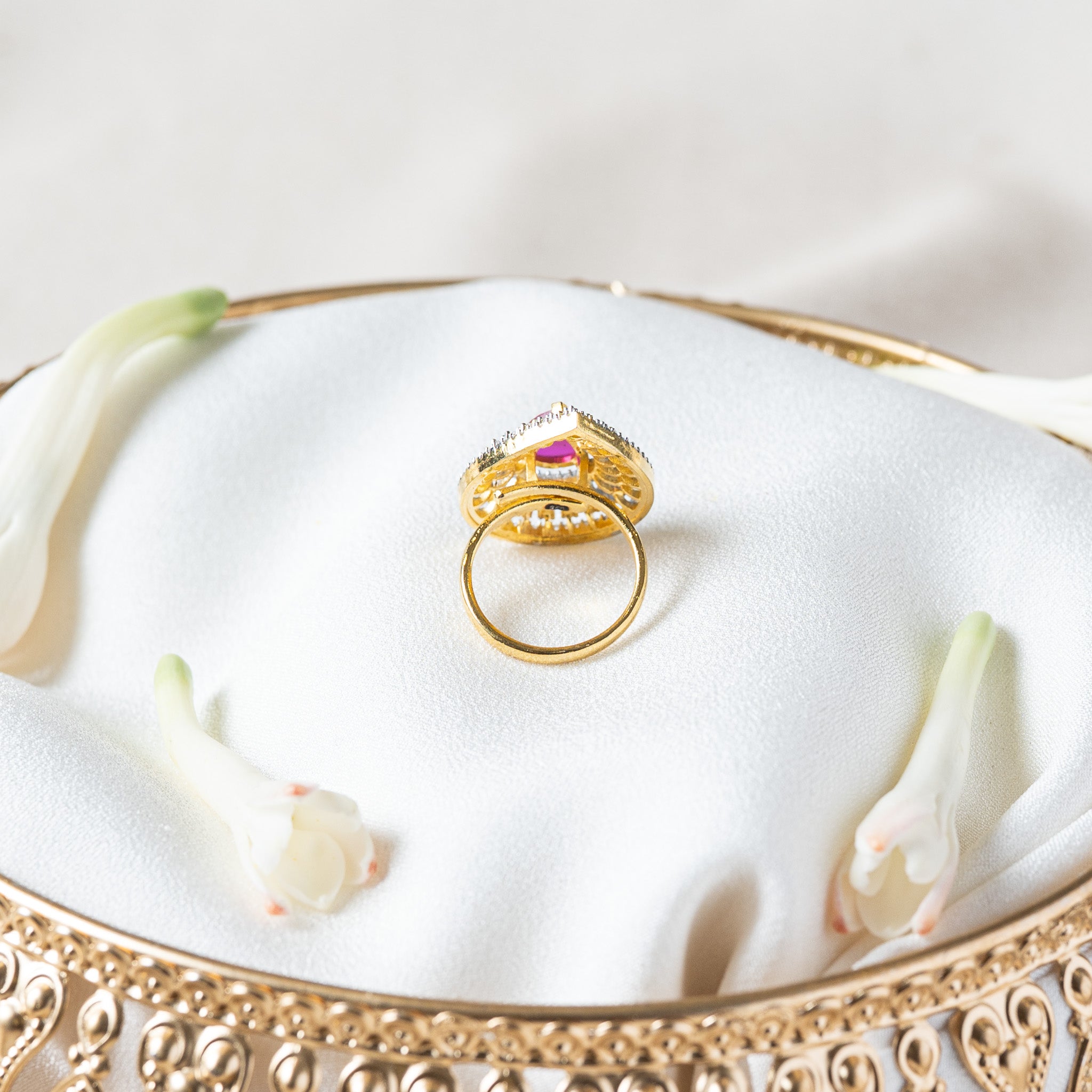 Reverse of the pink teardrop ring showing the continuous gold band, a fixed ring size