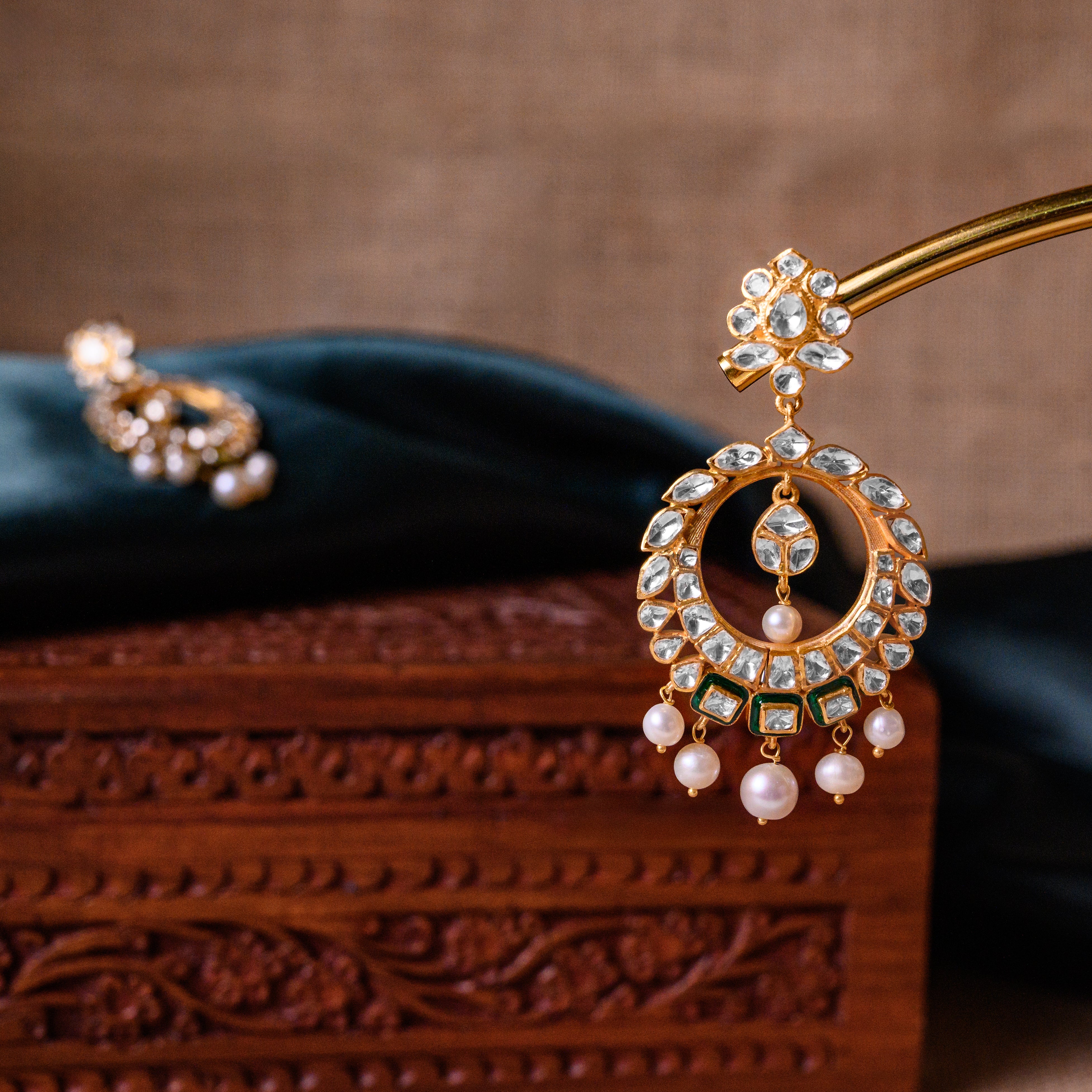 Side view of Solstice Polki Chand Bali green earrings with moissanite stones and freshwater pearls