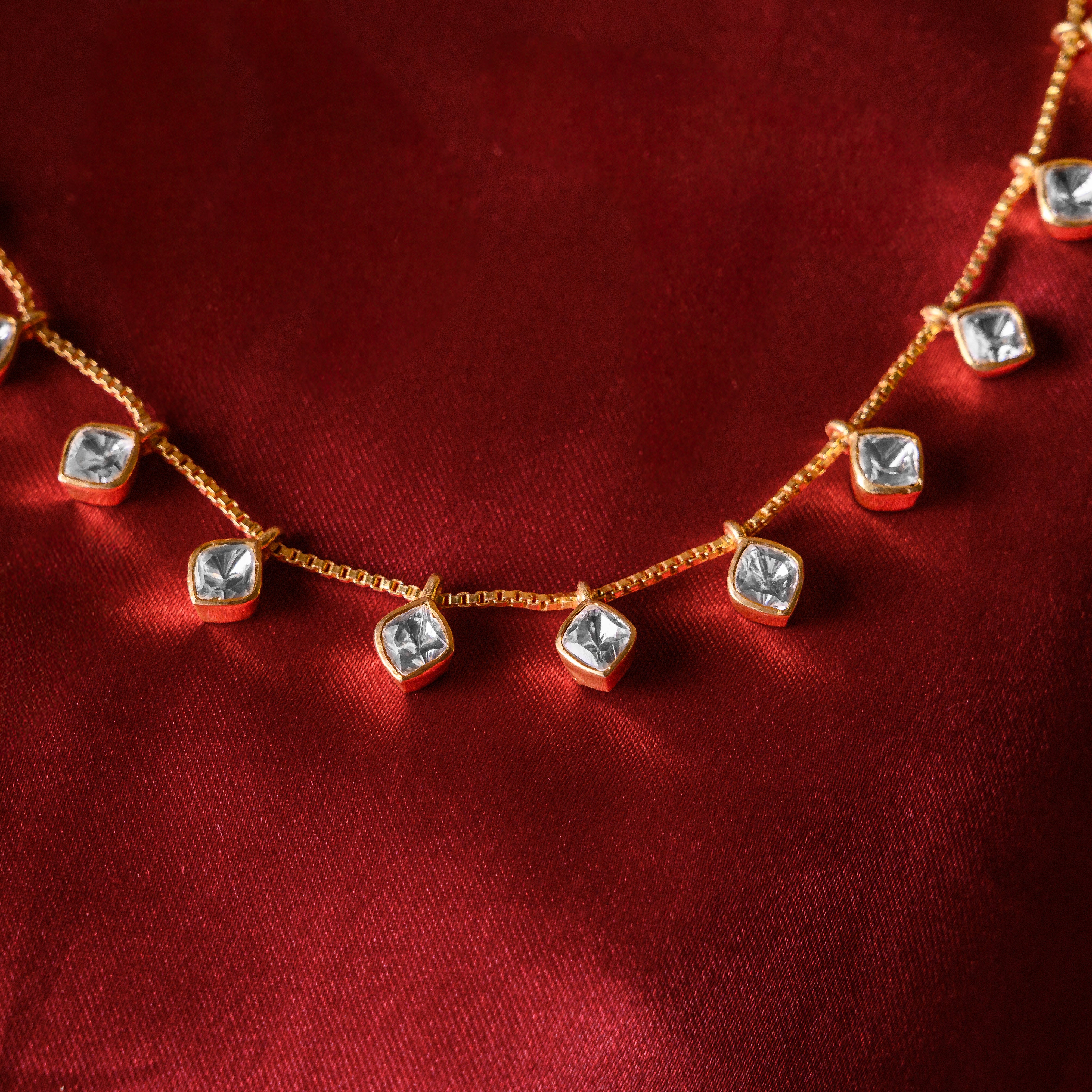Close-up of Glimmara Polki necklace showcasing minimalist moissanite charms