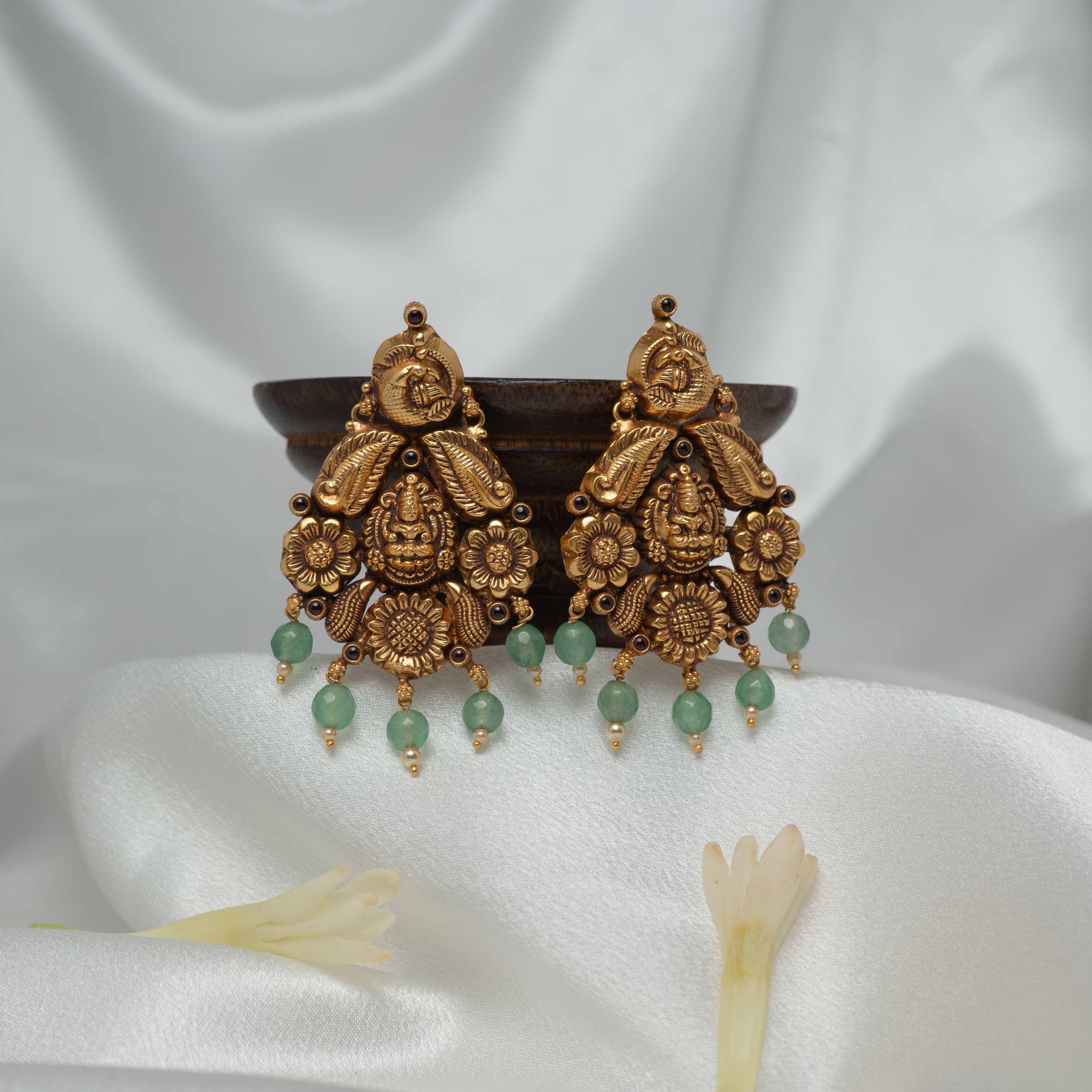 Detail of the round green bead and freshwater pearl fringe on the fan shaped earring