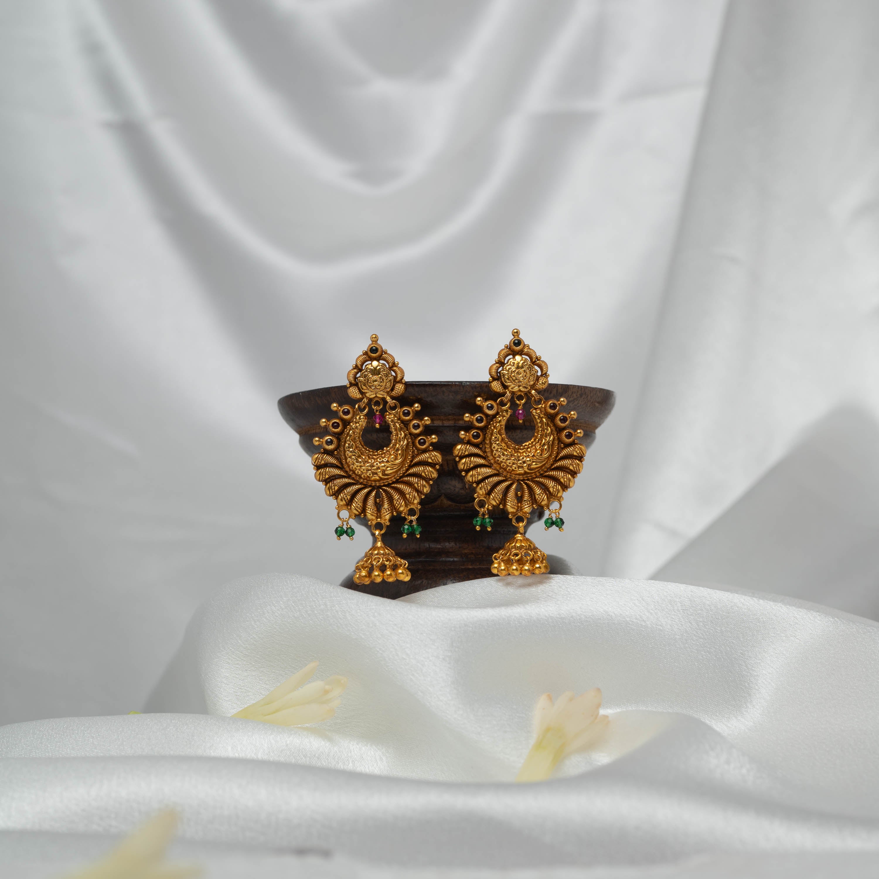 Close view of the pink and dark stones at the crown of the antique gold chand bali