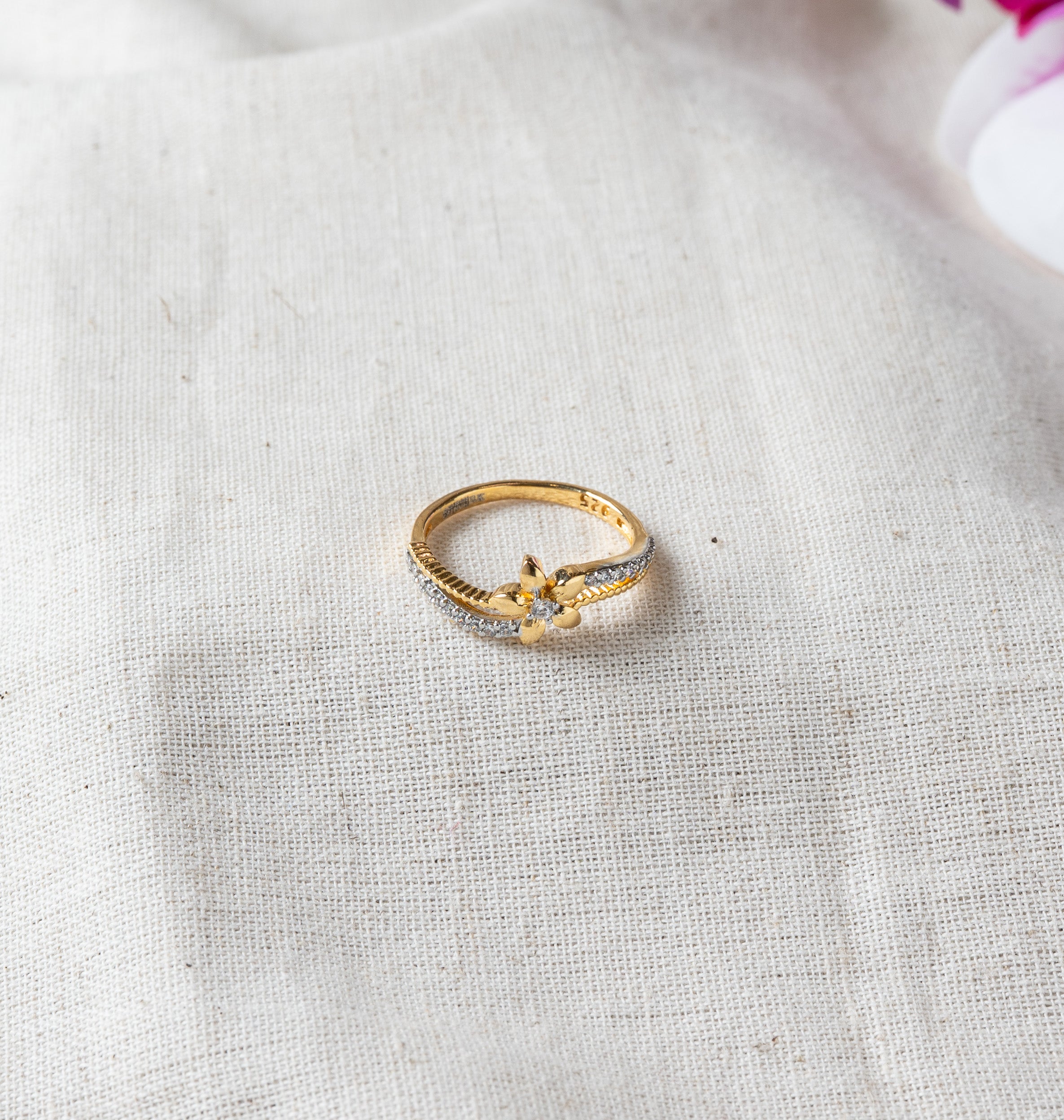 Close view of the flower motif and CZ lined band with the 925 stamp, gold plated silver