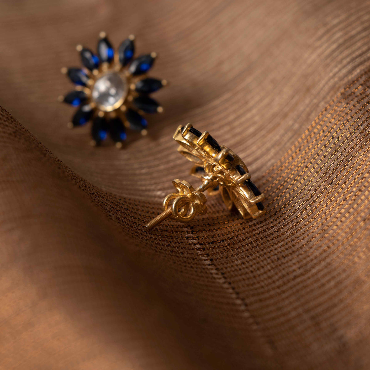 Angled view of the polki centre held inside the ring of blue marquise petals