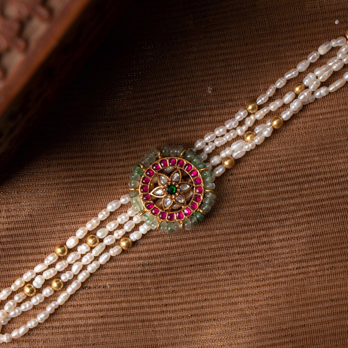 Four strand rice pearl bracelet with round kundan medallion ringed in green quartz beads, gold plated silver