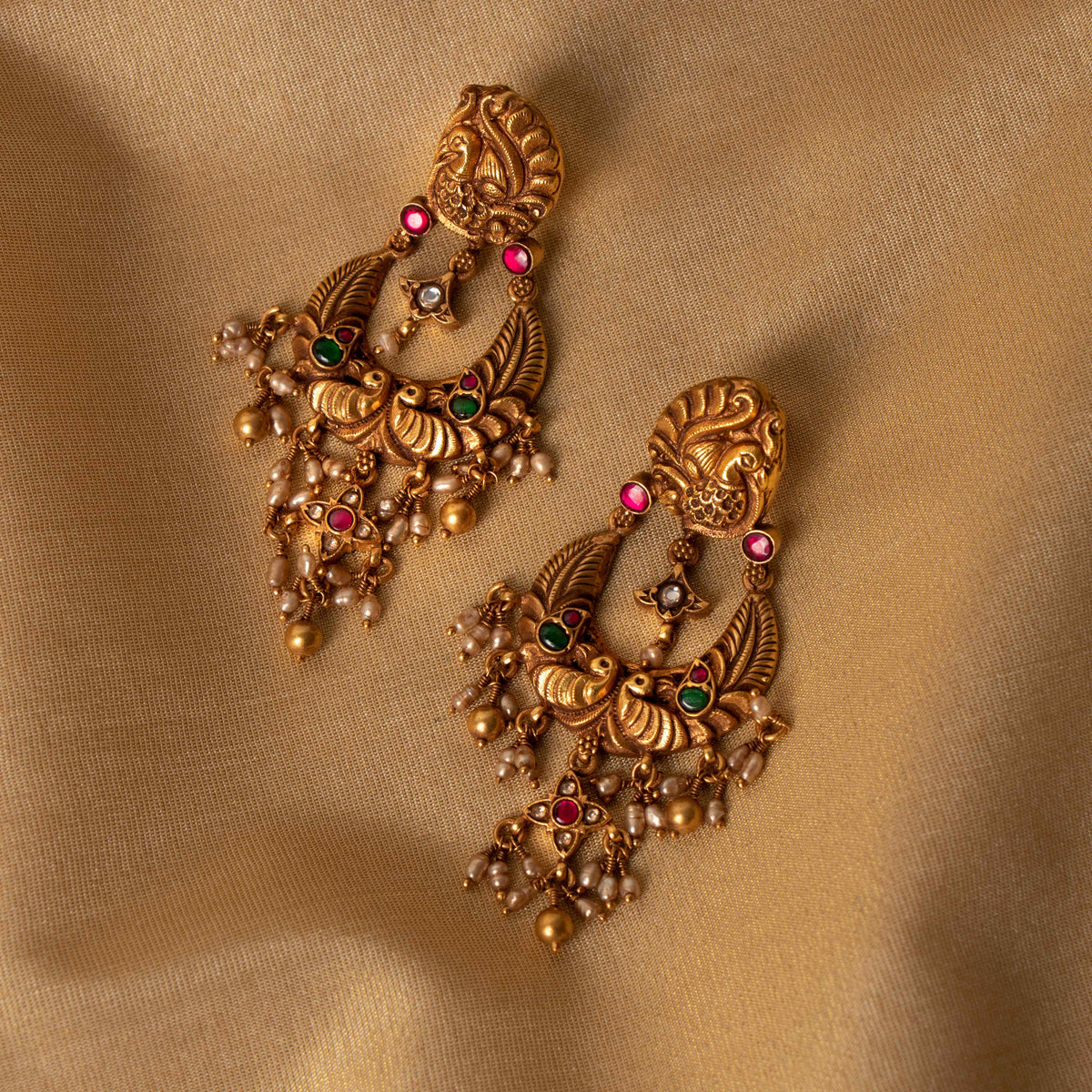 Nakaashi peacock chand bali with red and white kundan and seed pearl fringe, antique gold plated silver.