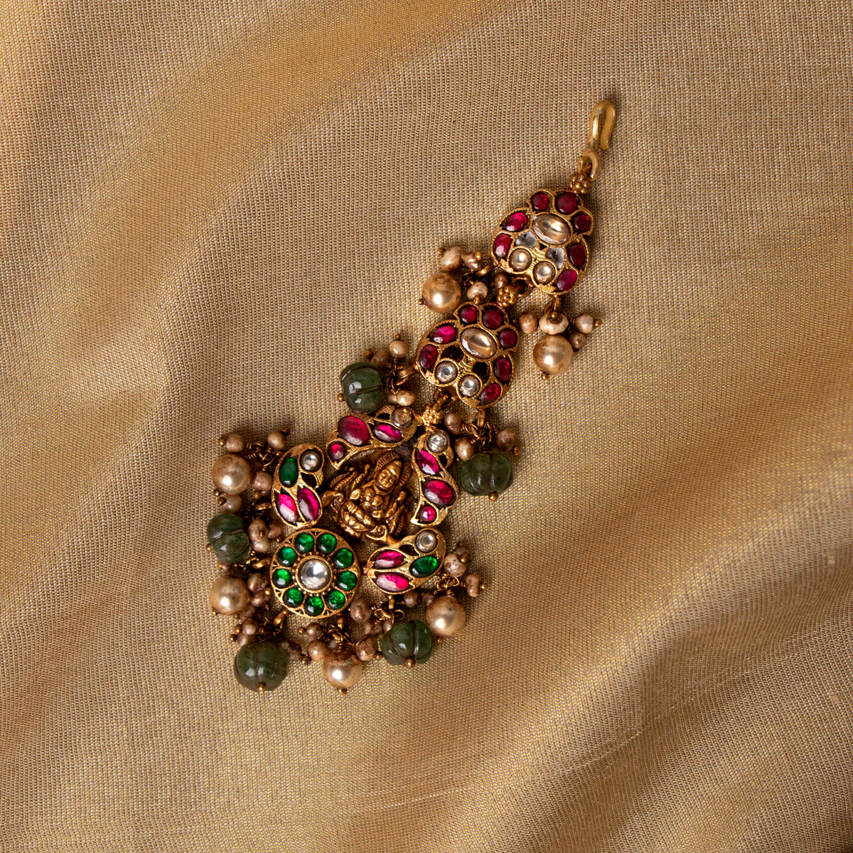 Lakshmi deity maangtika with red and green kundan and gold pearl drops, antique gold plated 925 silver.