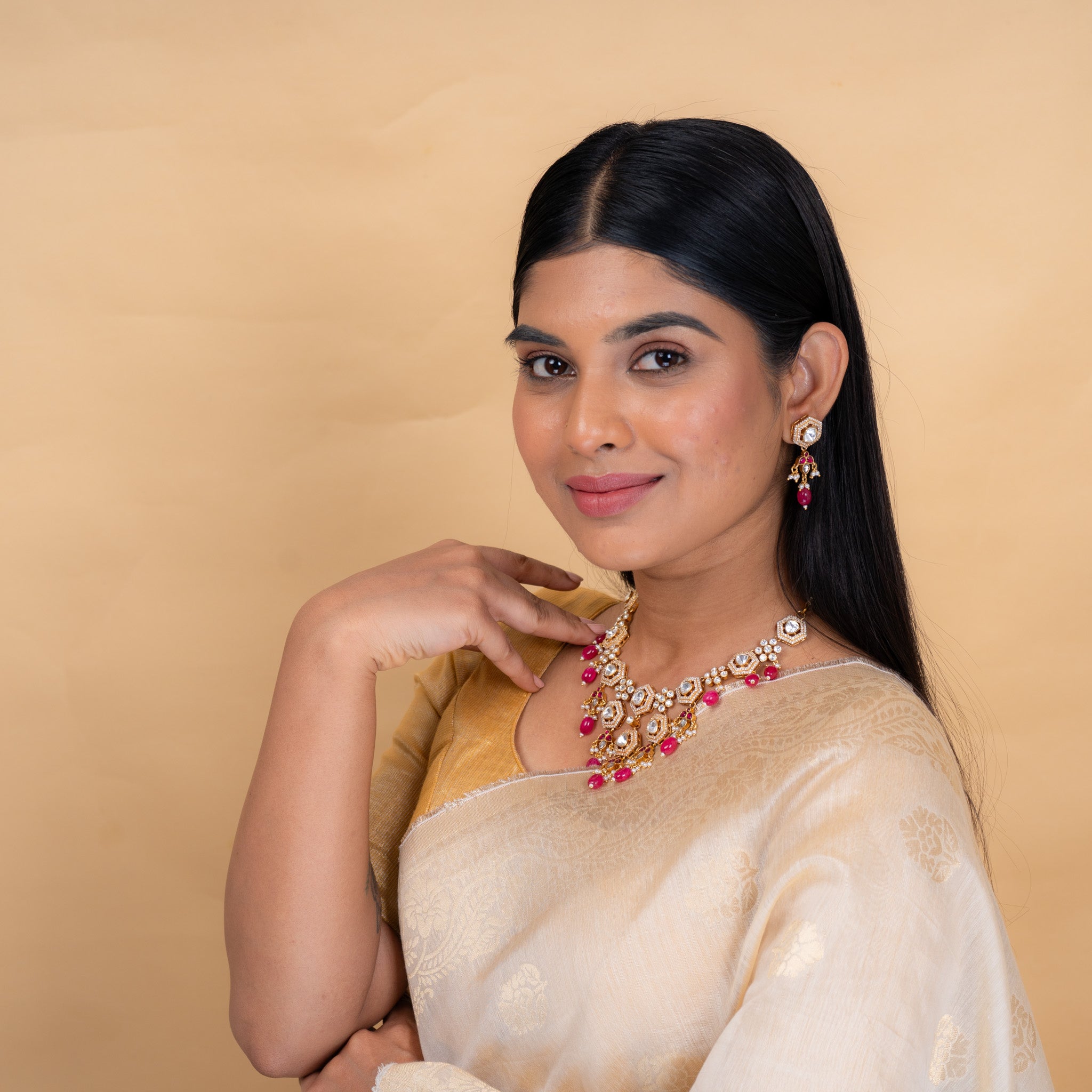 Model wearing Alaya polki hangings with pearl and red bead accents by Aurika
