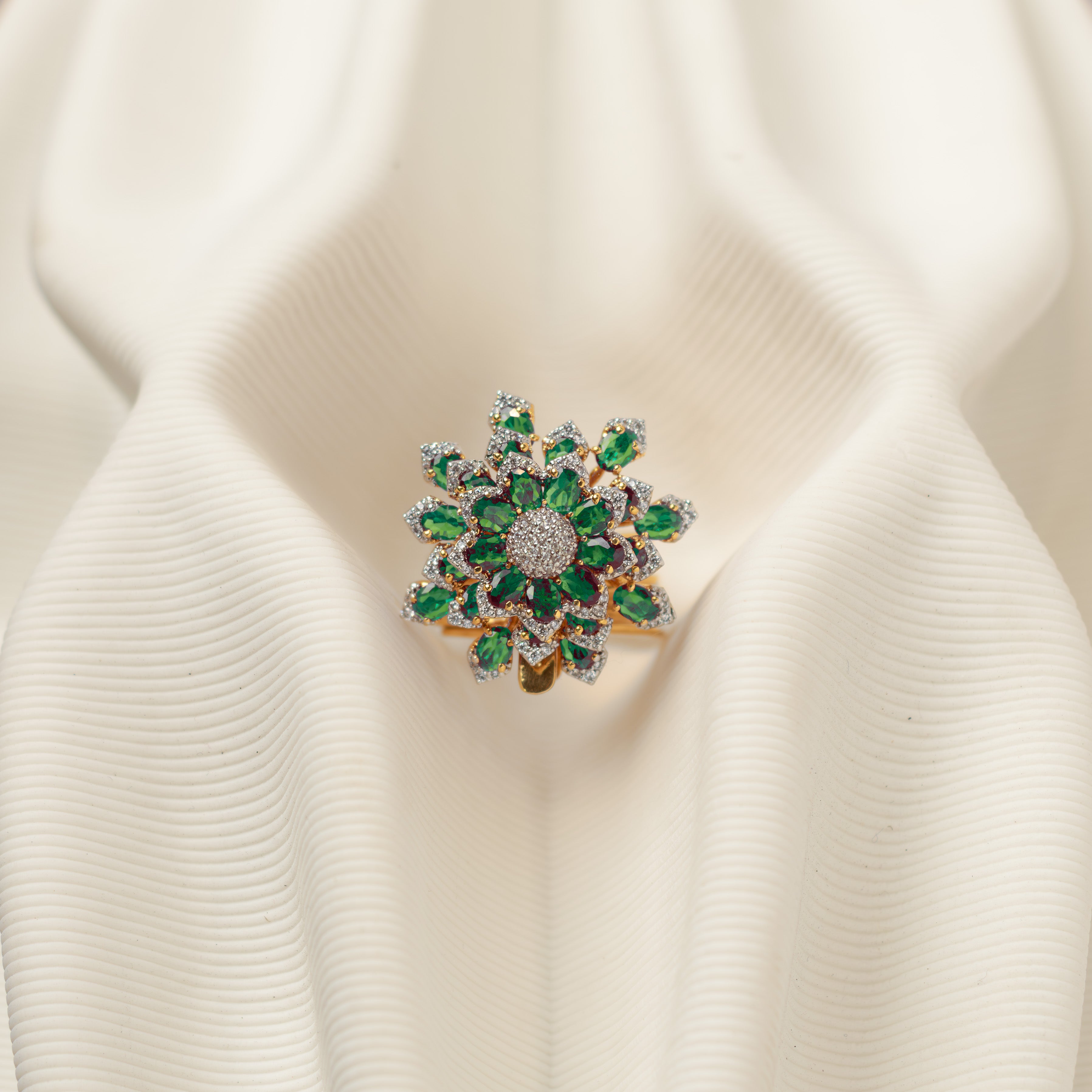 Close-up of Avira floral green CZ polki ring with white stone accents