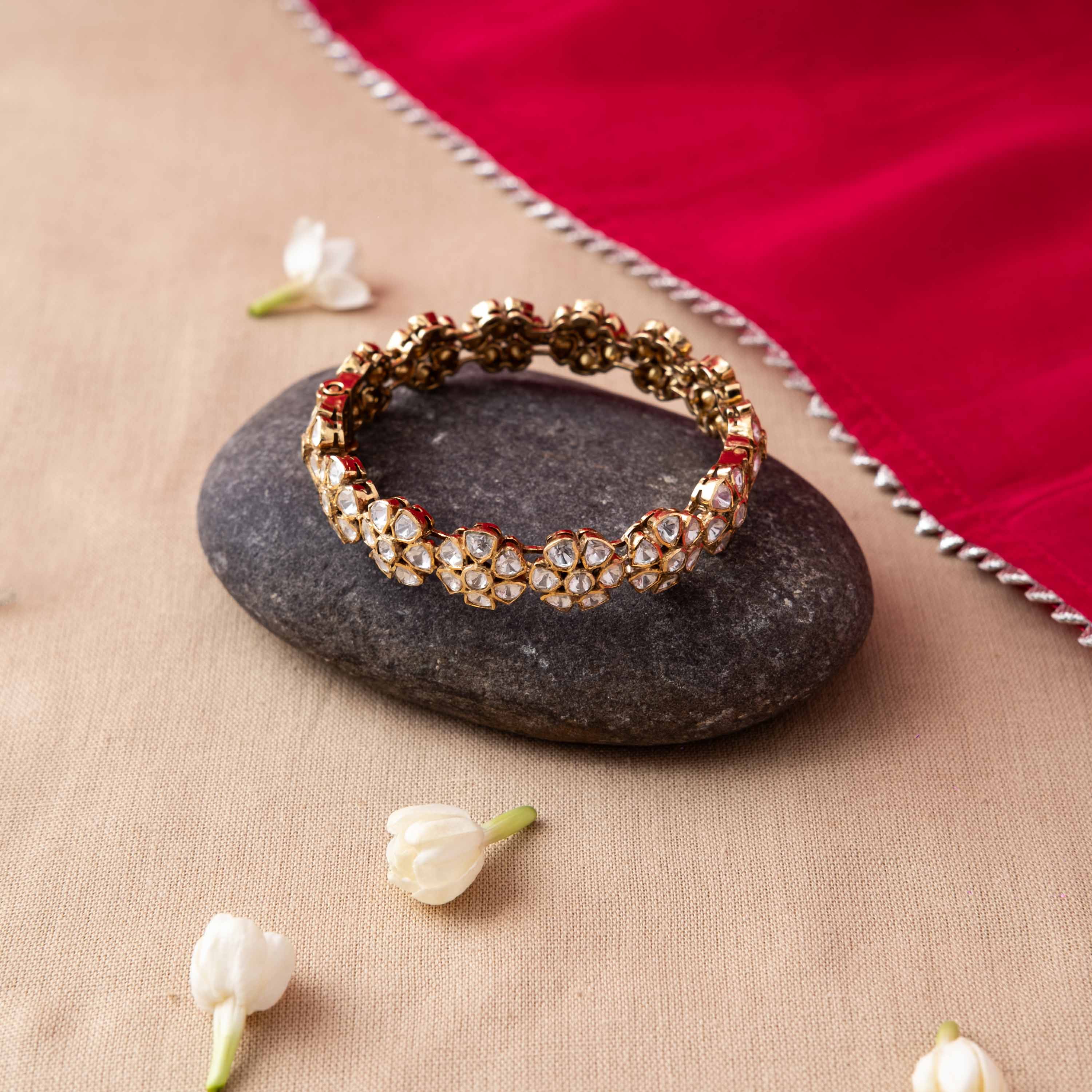Five petal polki florets linked end to end around a gold plated 925 silver kada