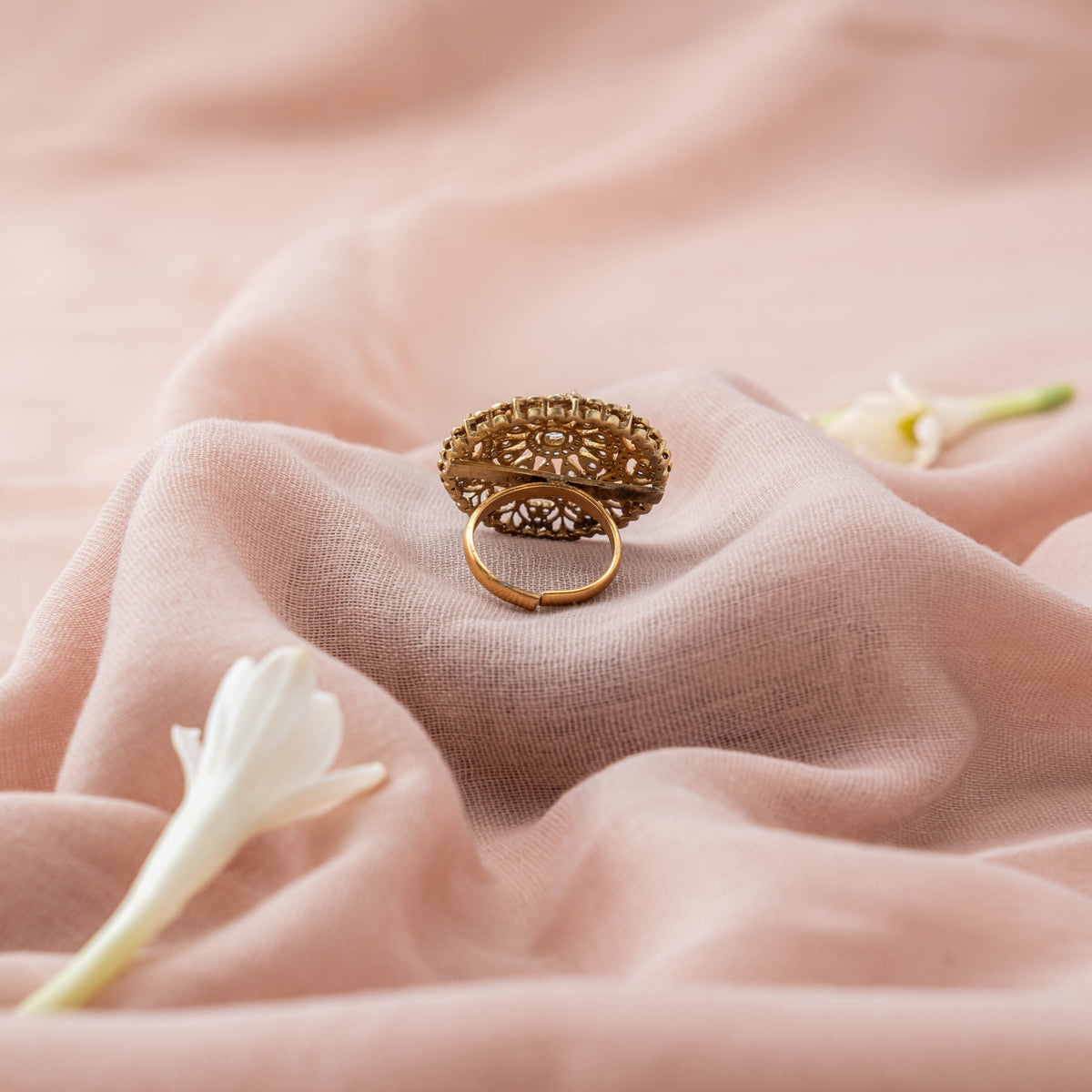 Open adjustable band behind the oval polki face of the cocktail ring in gold plated 925 silver