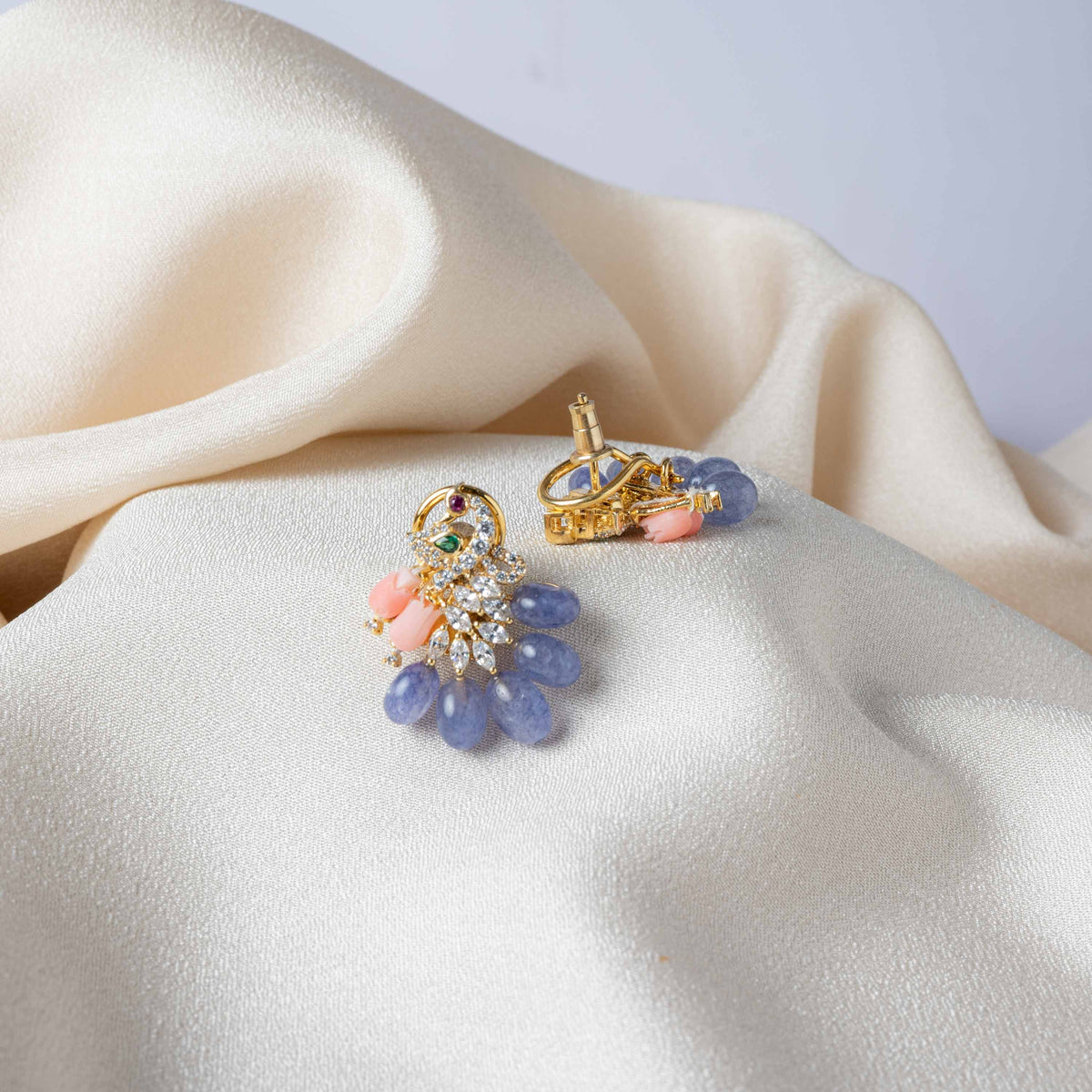 Close crop of the fish hook wire behind the gold plated CZ peacock earring