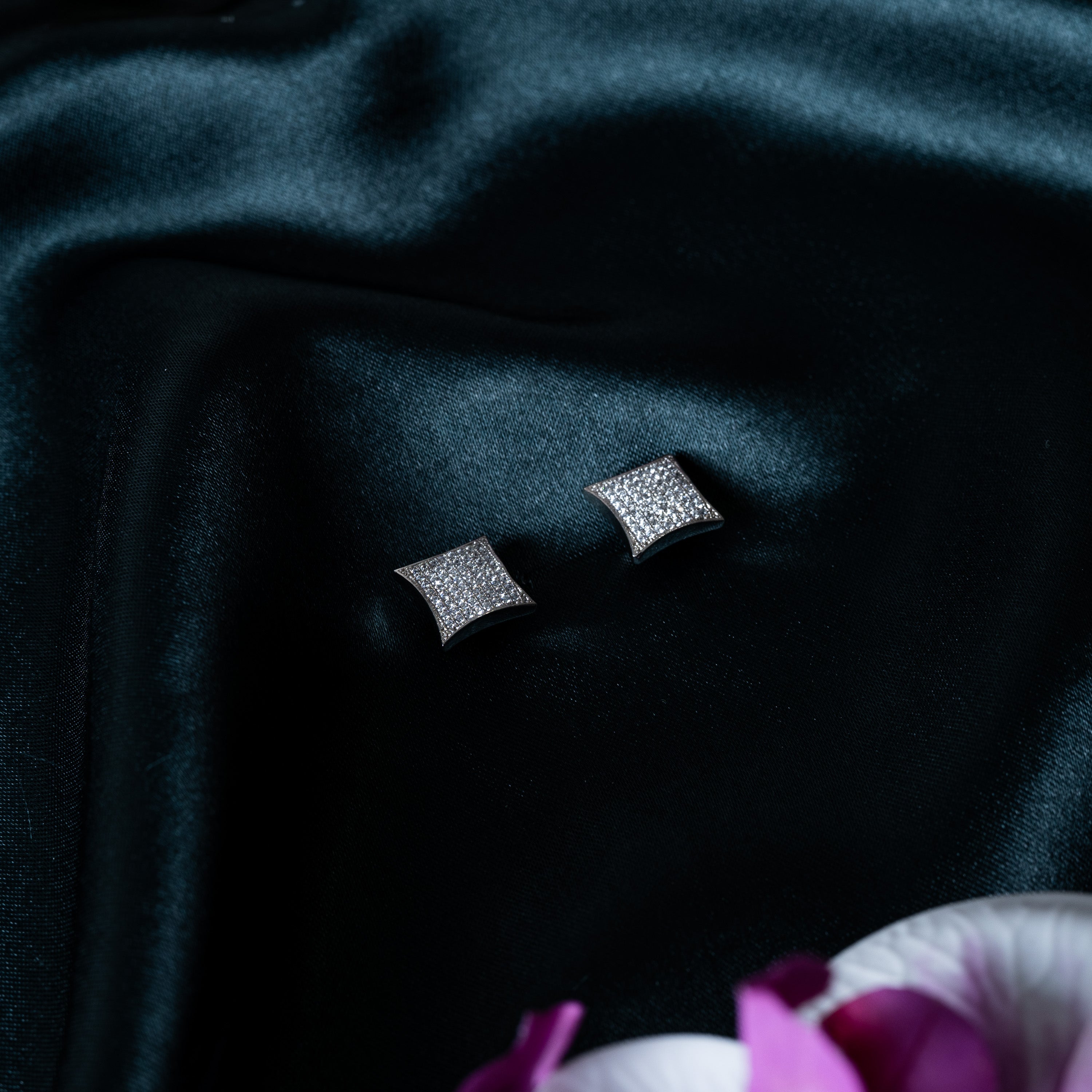Close crop of the pair of kite studs paved with CZ stones, rhodium finish 925 silver