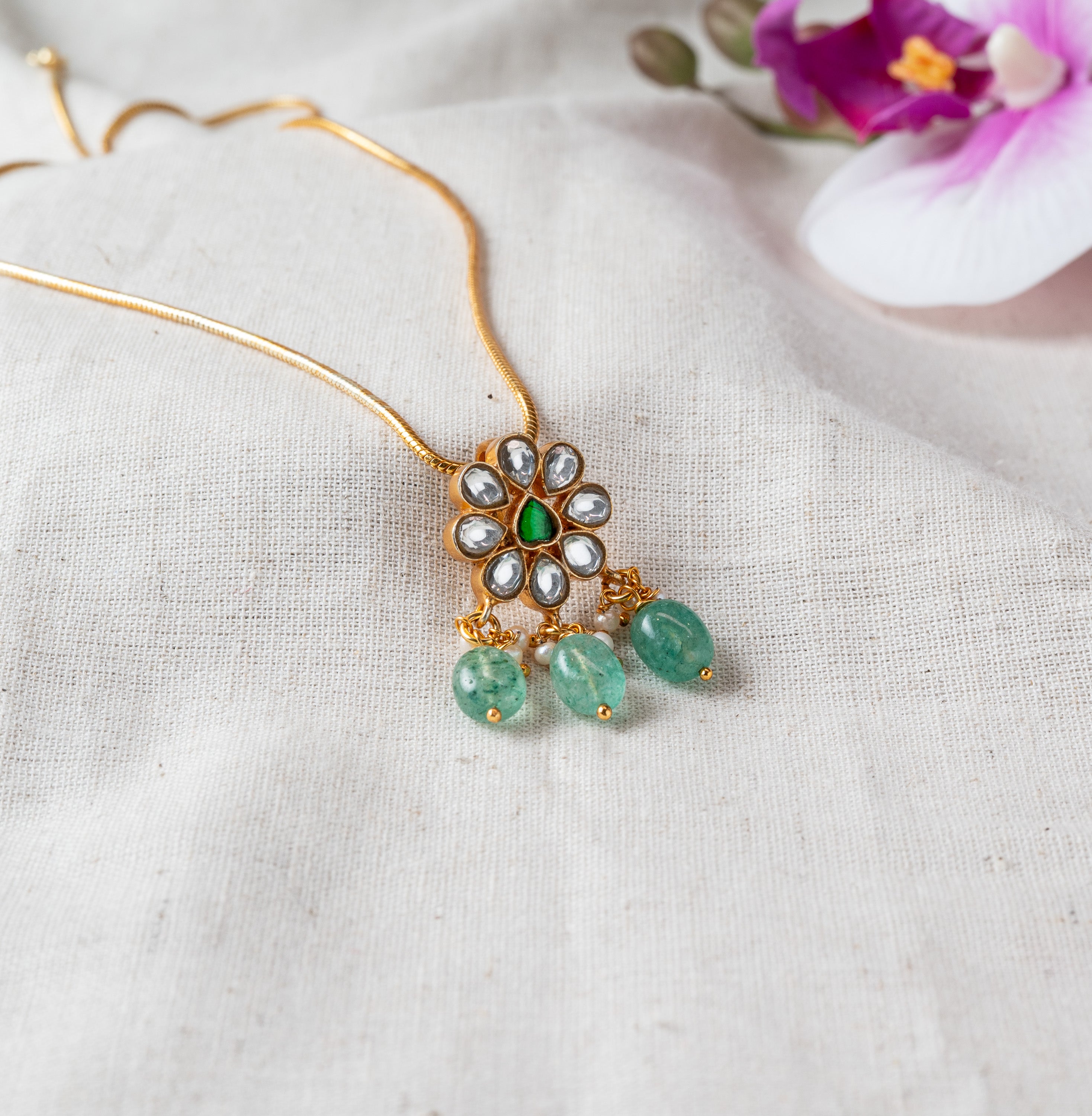 Polki floral pendant with a green centre stone, three green bead drops and pearls, gold plated 925 silver