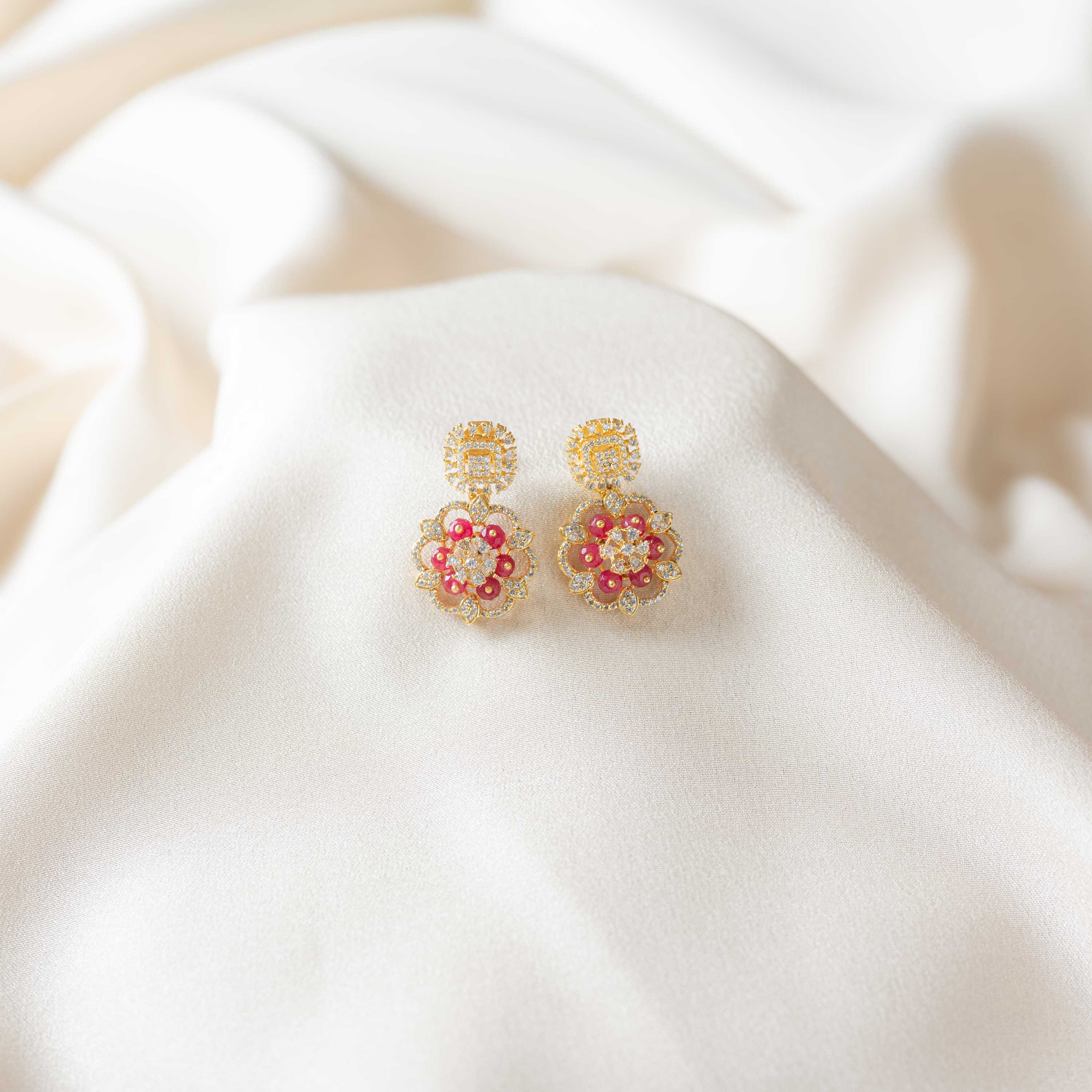 Rosira floral CZ hanging earrings in 925 sterling silver with gold plating and red crystal bead detailing
