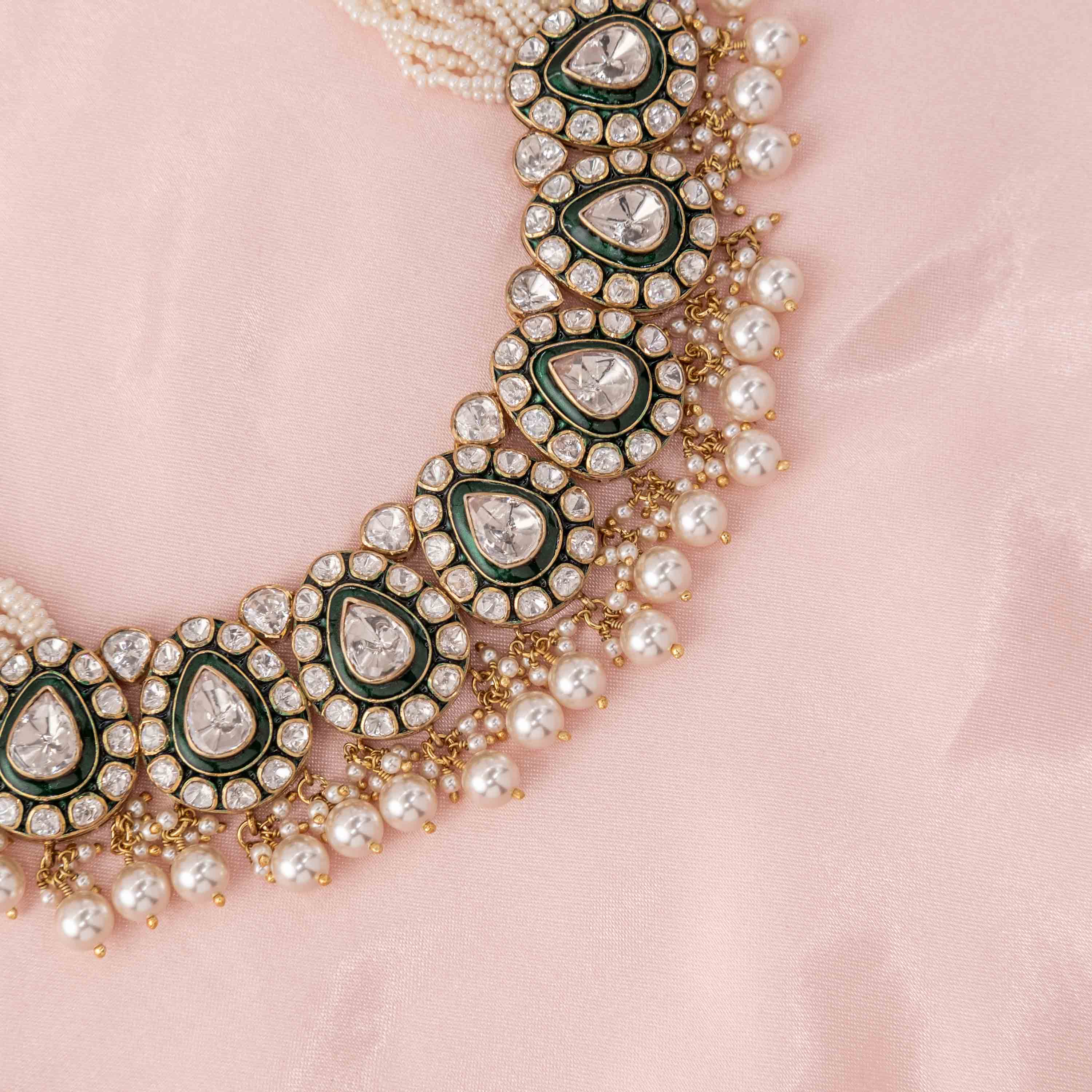 Close-up of Zehra Green Polki necklace featuring teardrop Moissanite Polki, green enamel motifs, sparkling CZ halo and pearl cluster detailing