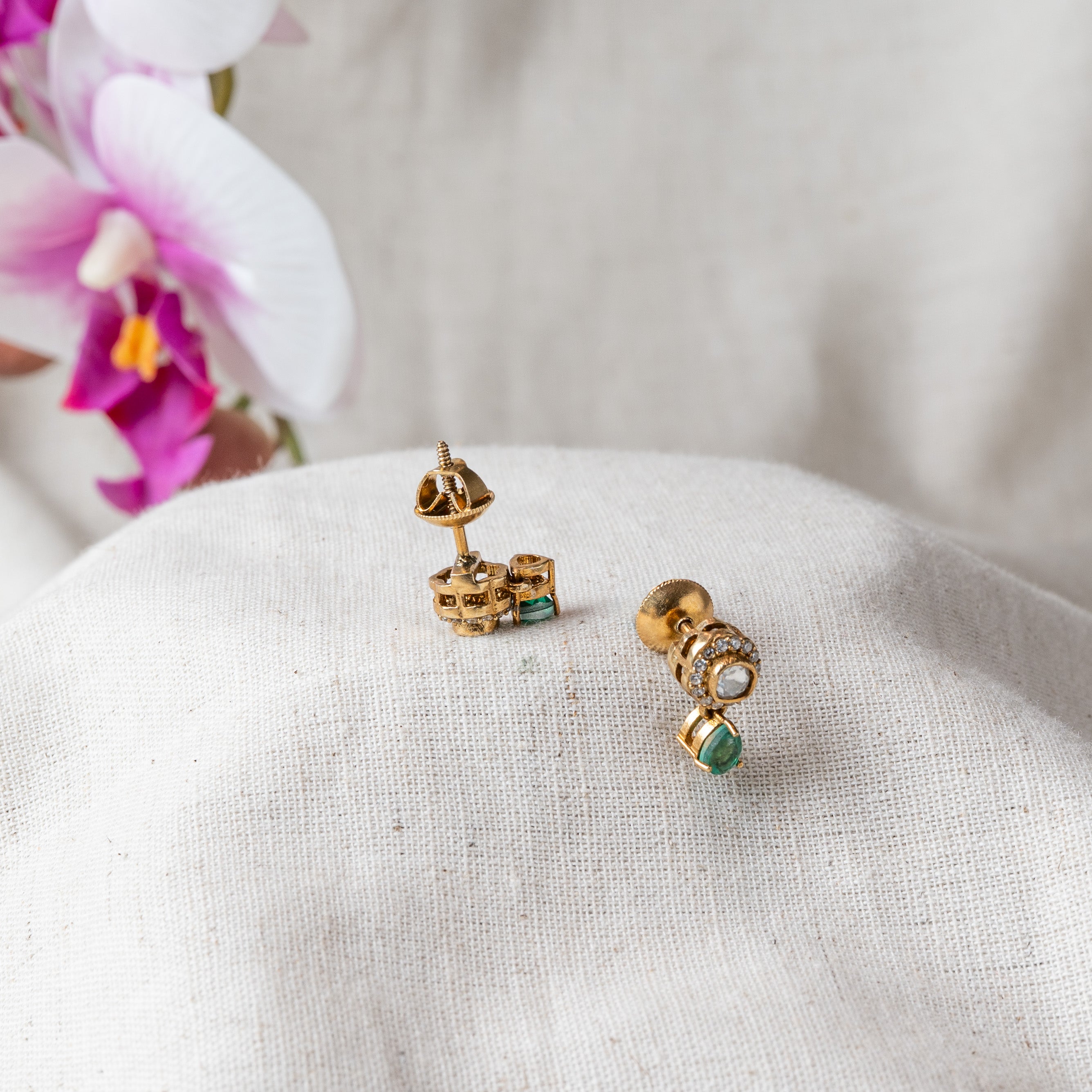 Stud pair with polki tops and emerald drops, one turned to show the screw back, gold plated silver