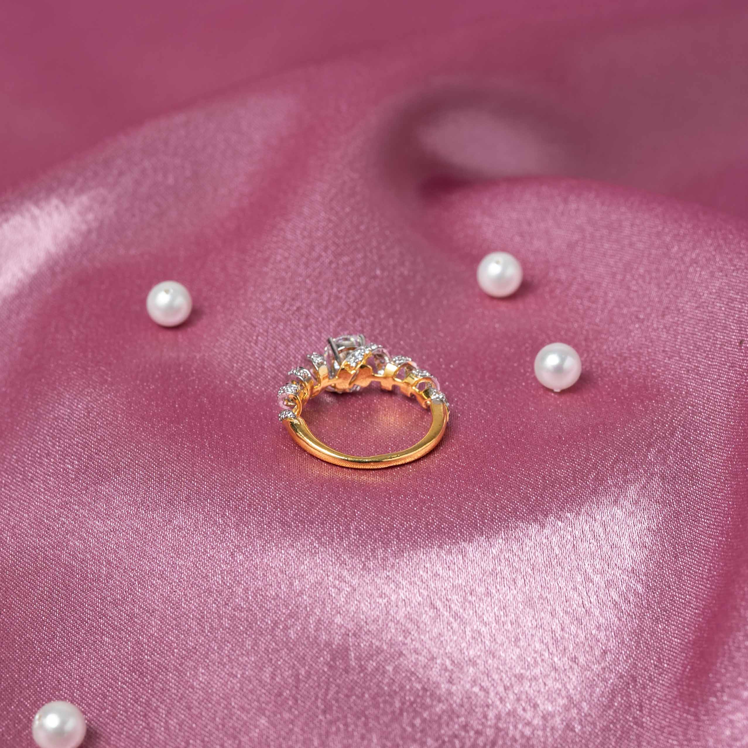 Top view of Aabha CZ ring crafted in 925 sterling silver with gold plating, brilliant solitaire CZ and sparkling pavé detailing
