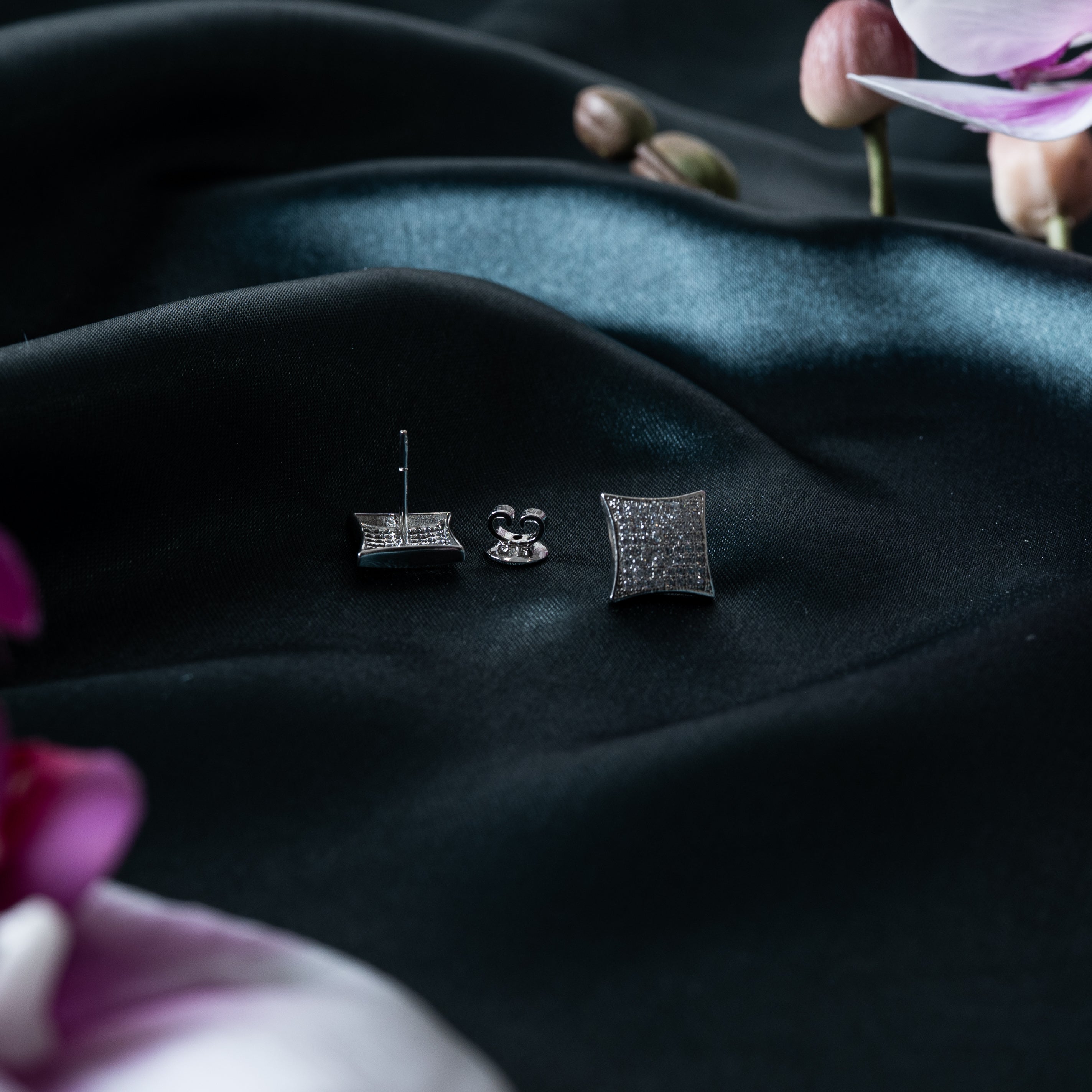 Kite studs shown with push backs, one turned to show the post, CZ pave in rhodium finish silver
