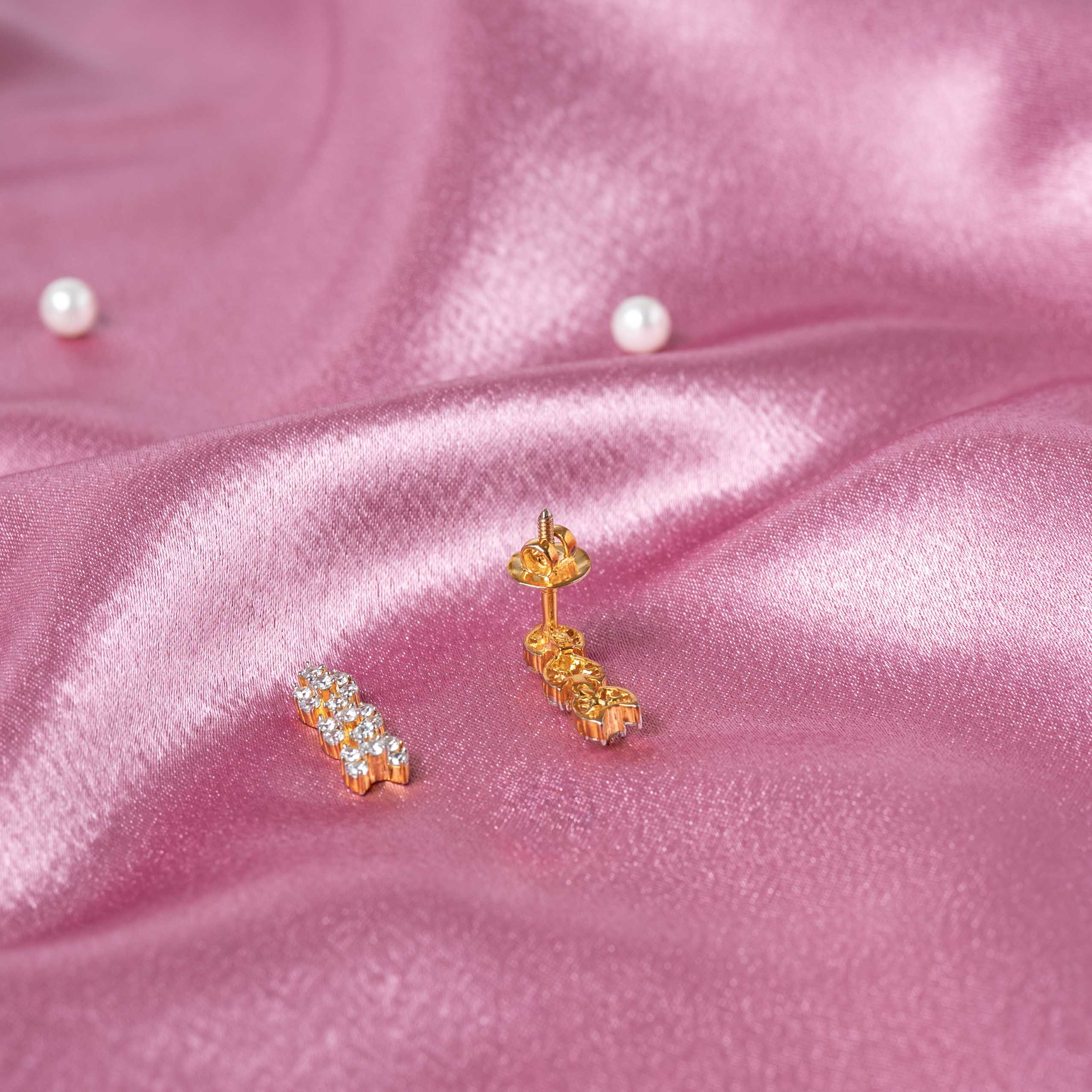 Angled view of the pair of CZ floral cluster drops in gold plated 925 silver