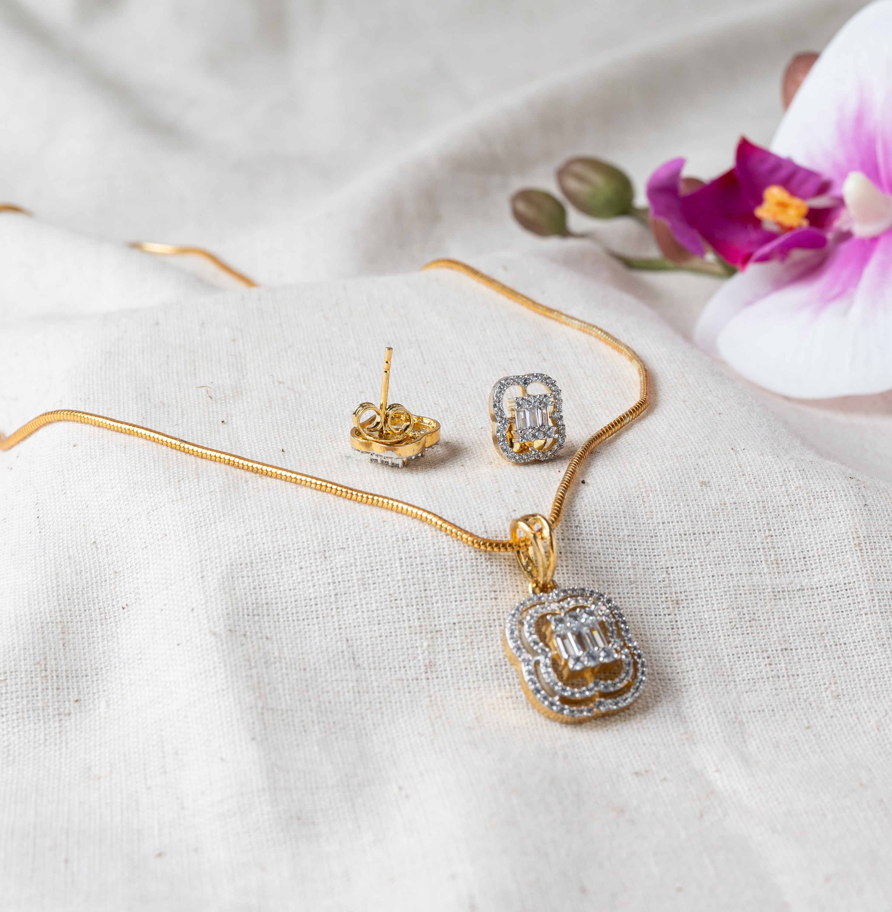 Pendant on its snake chain with one stud turned to show the post, gold plated 925 silver