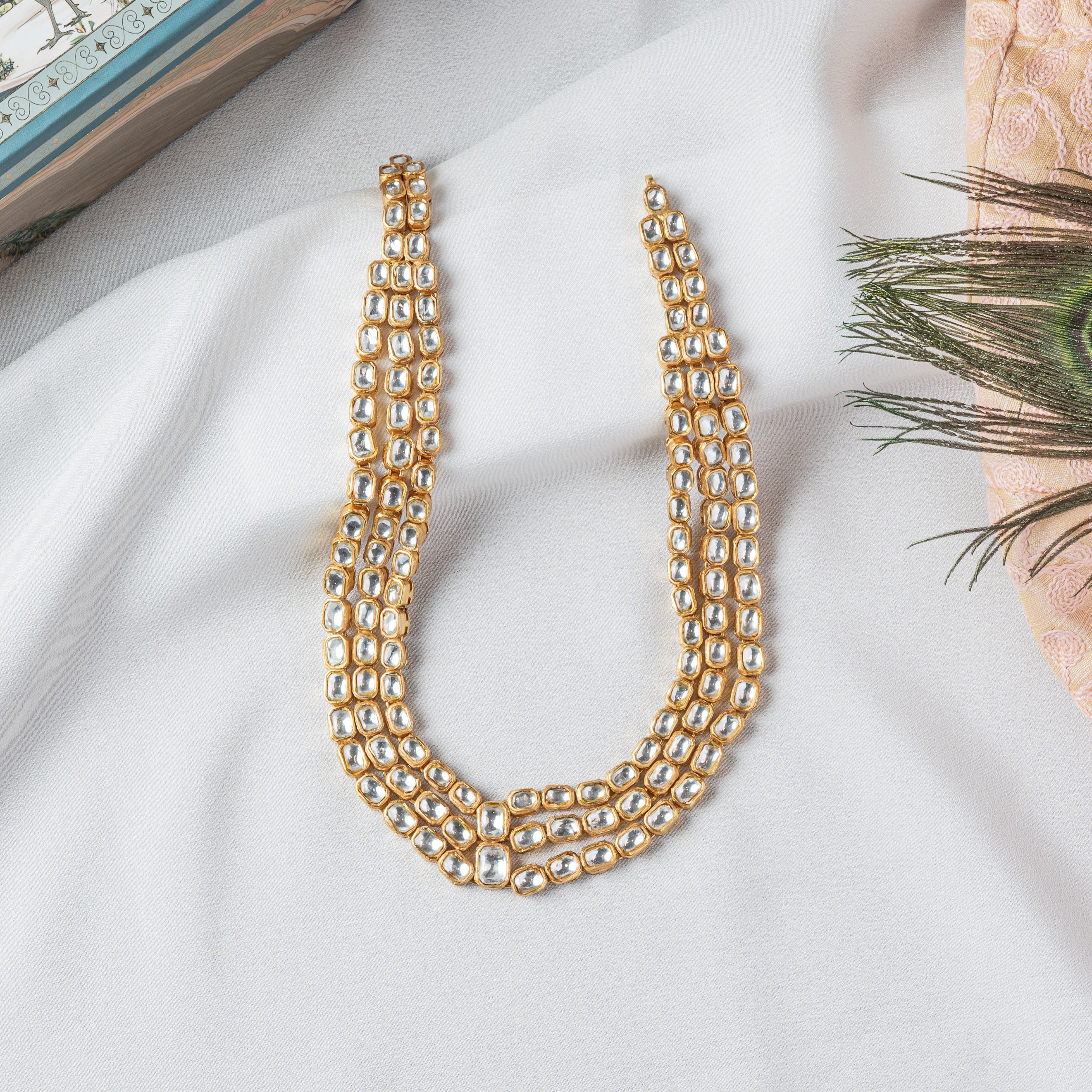 Close crop of the cushion cut polki stones across all three rows, gold plated 925 silver