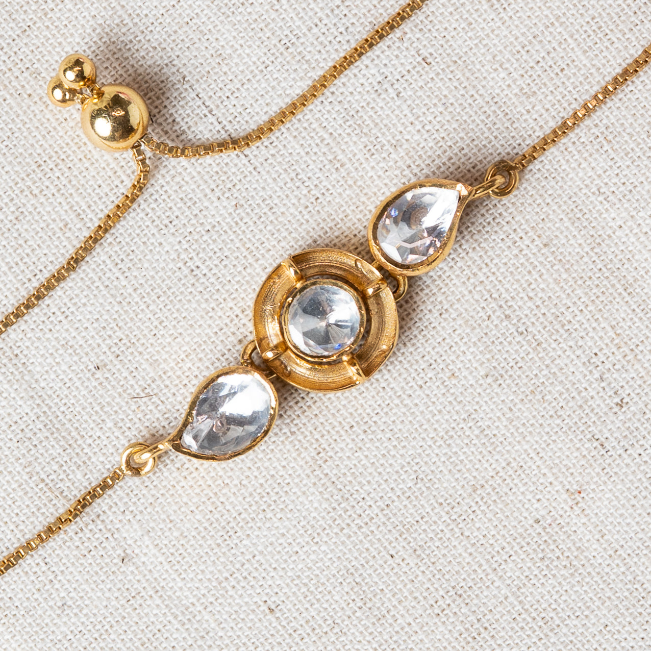 Close crop of the three uncut polki stones and adjustable slider bead, gold plated 925 silver