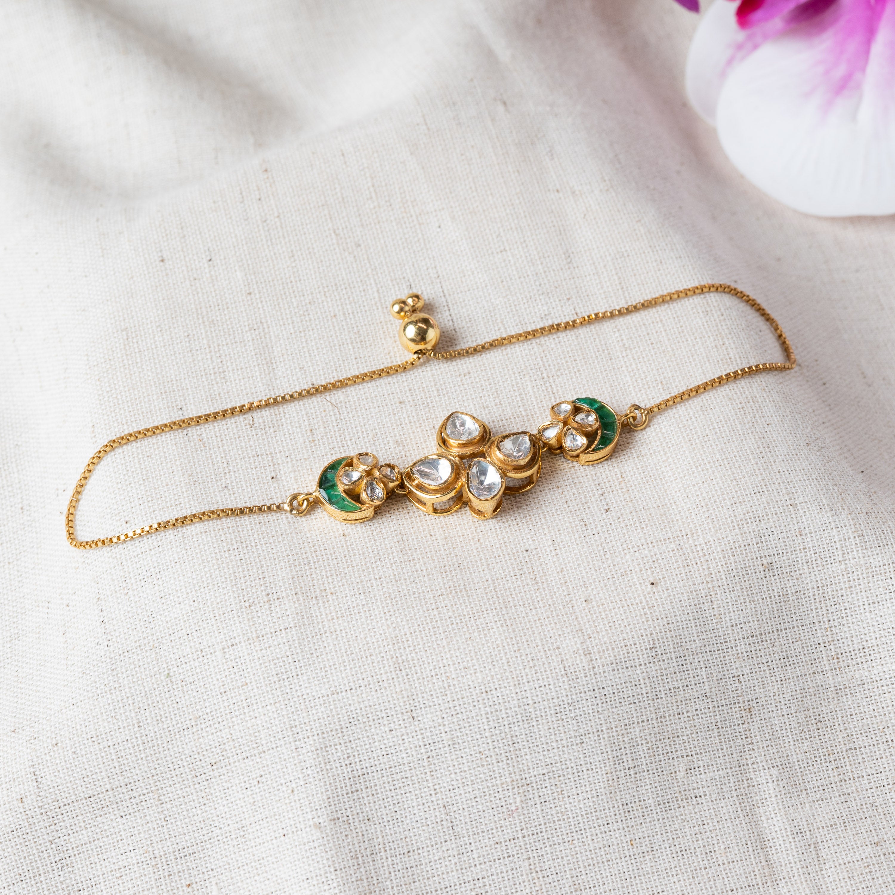 Polki floral bracelet with green stone crescents on an adjustable slider chain, gold plated 925 silver