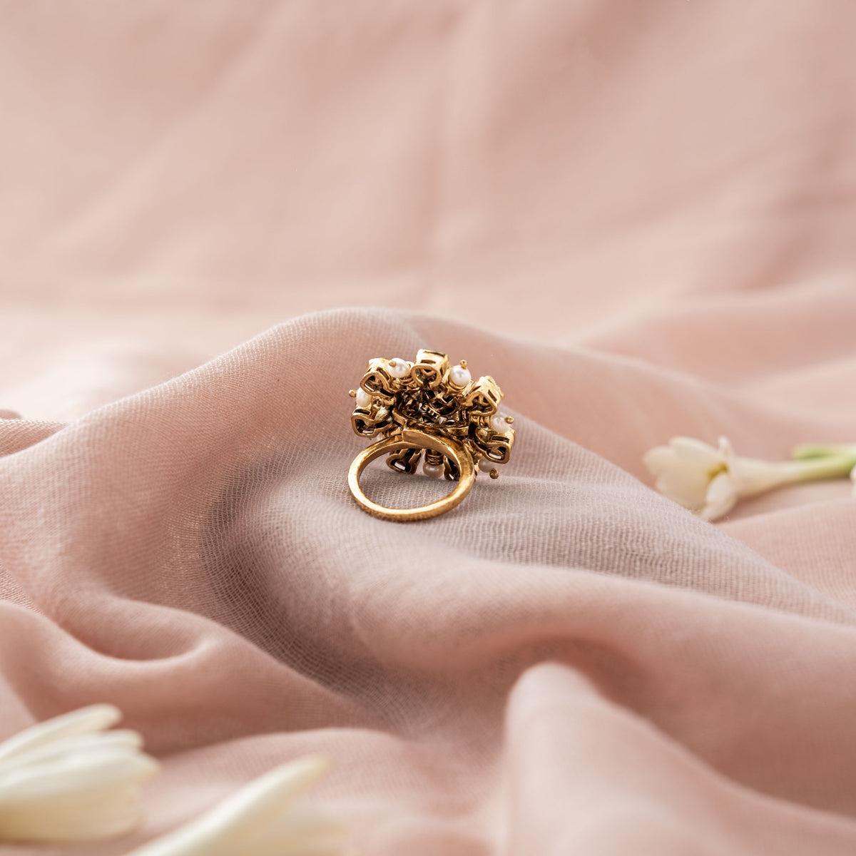 Three quarter view of the pear shaped cluster and its adjustable band, gold plated 925 silver